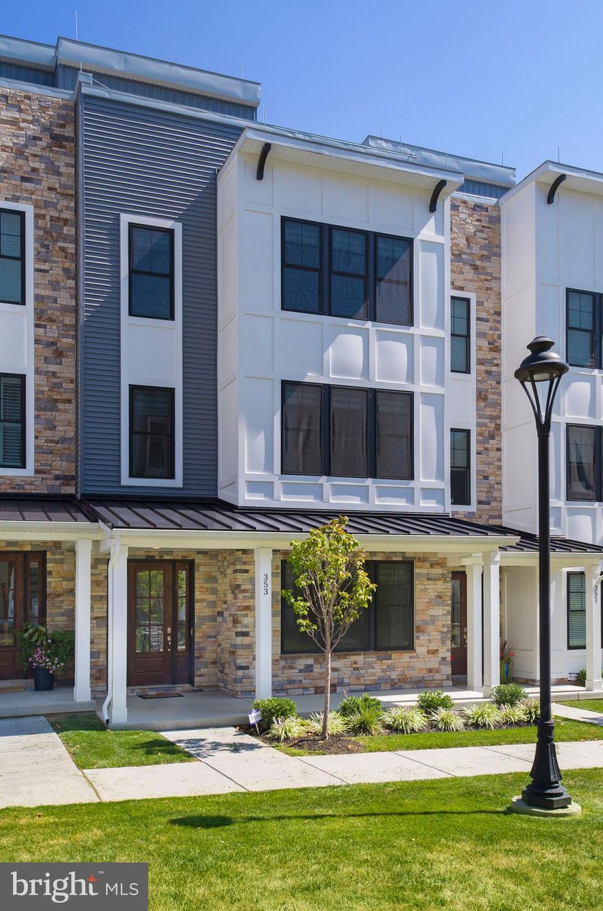 Welcome to The Towns at Newtown Walk, a sold-out and highly coveted community in the heart of Ellis Preserve. Perfectly blending modern design with Main Line convenience, this move-in ready townhome is quietly and privately situated within the neighborhood, yet just steps to shops, restaurants, and boutique fitness studios.

From the moment you arrive, the curb appeal shines with a full front porch overlooking a charming pocket park across the street. Inside, you’ll find a thoughtfully designed four-level floor plan connected by a private 4-stop elevator, along with a 2-car garage and spacious driveway that make everyday living easy.

The entry level boasts 9-foot ceilings and a bright front bedroom with its own full bath — ideal for guests, extended family, or a home office. Upstairs, soaring 10-foot ceilings and oversized windows flood the main living level with natural light. At the center is a chef’s kitchen with upgraded quartz countertops, 42” soft-close cabinetry, stainless steel appliances, and an impressive 10-foot island with plenty of seating. The open layout flows seamlessly into the dining area and inviting living room, anchored by a cozy gas fireplace.

The upper level is home to a serene primary suite with a generous walk-in closet, tray ceiling detail, and a spa-like bath featuring dual vanities and a walk-in shower. A second en-suite bedroom and laundry area complete the floor.

For those who love the outdoors, the rooftop terrace provides a private retreat with space to create an outdoor lounge, dining area, or garden — perfect for everything from quiet mornings to entertaining under the stars.

All of this comes with the unmatched convenience of Ellis Preserve living — just steps to Whole Foods, local cafés, and fitness studios, with quick access to major roadways, the airport, and public transit.

This is a great opportunity to own a townhome that offers both privacy and convenience in one of Newtown Square’s most desirable communities.