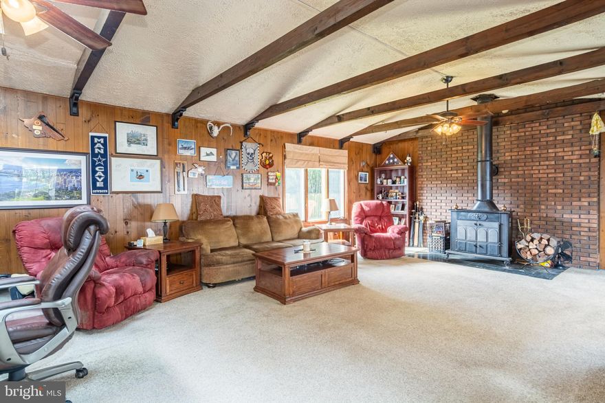 SPACIOUS MOVE IN READY CAPE COD THAT'S BUILT FOR ENTERTAINING!  Approximately 1,900 sq. ft. of living space featuring a large inviting living room, updated eat-in kitchen with ss appliances and a dining area, main level office, expansive family room with exposed beams and a wood stove, 2 main level bedrooms with a hall bath, upper level with 2 additional bedrooms and a full bath with a whirlpool tub, incredible yard featuring 2 patios, a storage shed, a workshop, and a firepit area which overlooks the rear yard, and easy driveway parking!  Updates include a roof with a 50 year warranty, and 200 amp power upgrade!