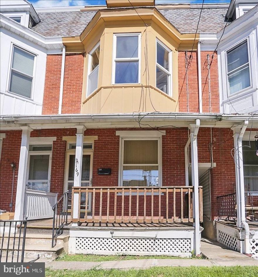 Spacious and full of character, this charming interior row home offers the perfect blend of affordability, character, and convenience. Step inside to a welcoming living room featuring an ornamental fireplace, a separate dining room ideal for gatherings, and an eat-in kitchen with sliding doors that open to a brand-new wooden deck. The fenced backyard and detached 1-car garage provide both privacy and practicality. Outside, enjoy the simplicity of a manageable yard — perfect for gardening, relaxing, or hosting summer barbecues. Offering 5 bedrooms and 1 full bath, this residence blends historic charm with modern convenience. This spacious 3-story home, perfectly situated within walking distance of downtown is just half a block from the park and swimming pool and walking distance to shops, dining, and entertainment. Whether you’re a first-time buyer, downsizing, or looking for an investment property, this home offers a wonderful opportunity to embrace the charm of this small town. Central air conditioning to keep you cool in the summer and all the appliances remain.