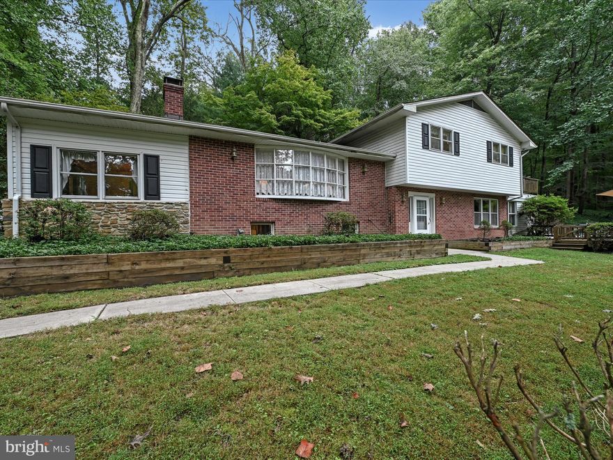 PRIVATE OASIS!!! Great location, backing up to the State Park. If you like to entertain ... This is the home for you! Beautiful in-ground pool. Large Tiki Bar. Decking and patio's surround the home and pool.  Additional grass area to play various outdoor games .  Easy access to the Rec room from the pool area enhances your entertainment abilities. From the pool patio, you can enter the second primary bedroom that includes a full bath. Preparing food for a crowd is no problem in the spacious eat-in kitchen with loads of cabinets and storage. Enjoy a quiet evening from your balcony that you access from the upper level primary bedroom. Spend some time relaxing by one of the the fireplaces in the cozy sitting area, or the welcoming living room. This home has so much to offer, to include hardwood floors under the carpet in the upper level bedrooms, hallway,  living room and dining room.  A generator so not to worry about power outages. Just bring your decorating ideas and move on in!  A one year HMS/Cinch Home Warranty included at settlement.  This is an Estate. Home is being sold “AS IS”.