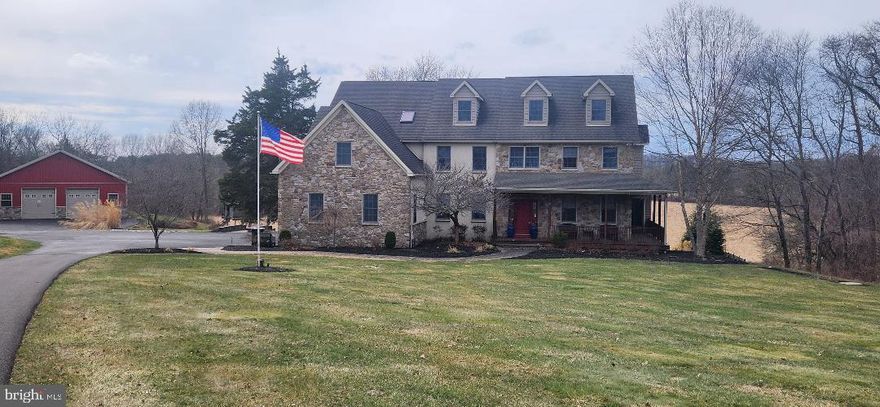 Bucks County estate on over 18 scenic acres, this custom-built Colonial farmhouse–style home offers a thoughtfully designed floor plan, expansive views, and a peaceful setting surrounded by open pastures and wooded areas. The stone and stucco exterior is complemented by newer custom decks on both the first and second levels, providing wonderful spaces to enjoy the panoramic landscape.
The main level welcomes guests with a dramatic two-story foyer that opens to the living room and formal dining room. A two-story family room with a stone fireplace and a wall of windows brings in abundant natural light and overlooks the backyard. A spacious office offers a bright and comfortable work-from-home environment.
The kitchen features stainless steel appliances, granite countertops, gas cooking, and generous workspace. A powder room and an expansive laundry room complete the main level.
Upstairs, the main bedroom suite includes two walk-in closets, a sitting room with fireplace, a large primary bath, a bonus room, and a staircase leading to an additional unfinished attic area offering potential for future use. Additional bedrooms and full baths provide comfortable accommodations for family and guests.
The fully finished walk-out basement features durable luxury vinyl plank flooring and includes a full bathroom, creating flexible space for recreation, hobbies, or extended living.
Additional features include an attached three-car garage, whole-house generator, and a custom in-ground heated pool with spa. A substantial barn offers parking for up to ten vehicles and includes an unfinished second story, providing additional possibilities.
Conveniently located near the shops, dining, and cultural attractions of both Doylestown and New Hope, with access to major commuter routes.