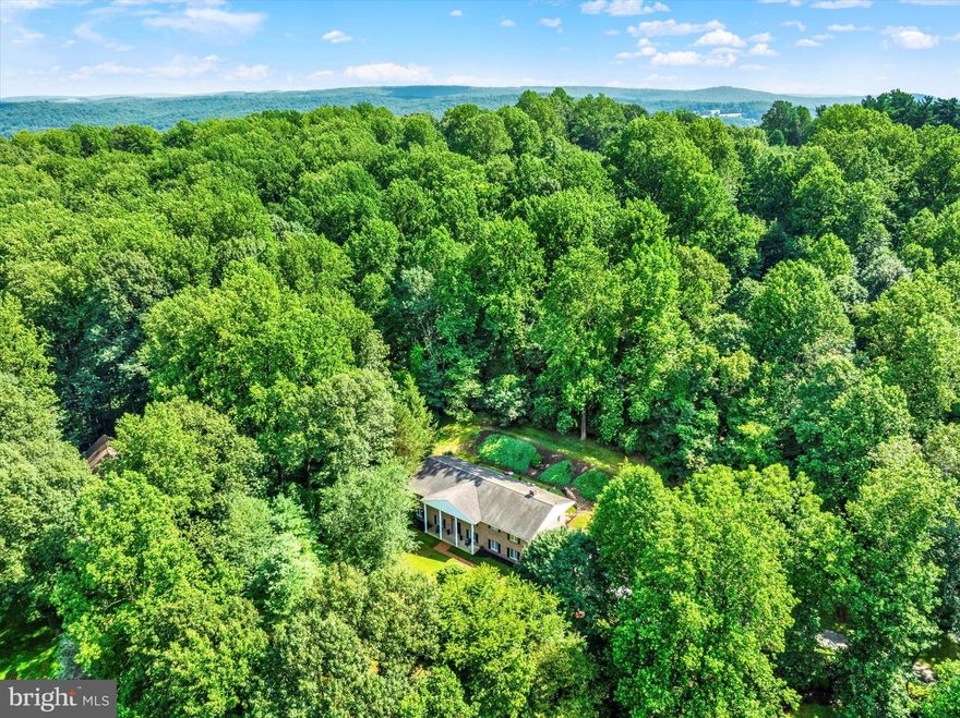 You must see this beautiful, spacious, solid brick, 4 bedroom, 4 bathroom home located on a private wooded 1.82 acre lot in Governor Mifflin School District. This home offers an amazing 4,408 sq ft of exceptional living space! Enter through an impressive open foyer with imported tile flooring, a dramatic center spiral staircase, and an open lower level that would make the perfect in-law suite, with a large bedroom, full bathroom, and dedicated living area/media room with lots of windows, recessed lighting, custom built-ins, and new flooring. Upstairs, which can be also accessed from the lower level via a second staircase, has been meticulously updated with new wood flooring and fresh paint throughout. The attractive eat-in kitchen is also sure to impress with its custom cherry cabinets, built-in appliances, and new quartz countertops, and it flows nicely into the formal dining room that is complete with chair rail molding. Next, the sizable formal living room boasts beautiful custom built-ins, and a large bow window to bring in lots of natural light. You will also find a family room/den with an impressive stone wood-burning fireplace and sliding glass doors to the backyard that is sure to become your favorite room in the house. Also on this main level you will find three additional bedrooms with the master bedroom suite having exterior glass doors leading out to the back deck, three full bathrooms, two completely renovated and the third updated with a new vanity, and a convenient main floor laundry room with a utility sink and a door to the outside. And you will just fall in love with the outside! The backyard is completely private with a gorgeous wooded backdrop where it is not unusual to see wildlife, including a mother deer who has been strolling by with her fawns lately. And I should also mention that this home was constructed with quality local Glen-Gery brick, and includes a 2-car side entry garage, a long driveway, a turnaround space, and an additional drive area along the top of the property for plenty of parking. There is also a huge storage space on the lower level that could continue to be used for storage, or that could easily be finished to add another 1,000 sq ft of living space to the lower level. Other notable features of this great home include: a newer roof (2015), newer central HVAC (2020), 2 new split units added downstairs (2024), newly remodeled bathrooms (2025), 4th full bathroom added downstairs (2023), newer hot water heater (2021), new insulation in attic (2024), updated lighting (2024), and newly installed back deck (2025). And, to top it off, a one-year Cinch home warranty is included for your peace of mind! So call today for your private showing! You will not be disappointed!