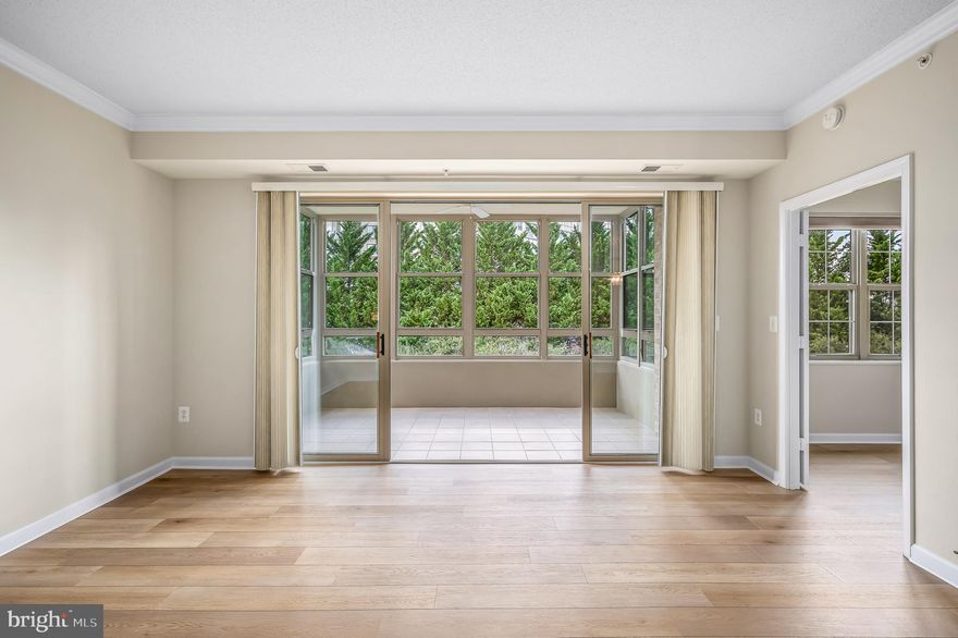 Wonderful opportunity at a great price to own this elegant two-bedroom, two-bathroom residence offering a harmonious blend of modern comfort and serene tranquility.  Upon entering this home, you are greeted by BRAND new luxury vinyl plank floors that extend throughout the condo, creating a seamless flow and a sense of sophistication. The freshly painted walls serve as a perfect backdrop for your personal touches while complementing the peaceful views of the surrounding nature.

Freshly painted, this home features an open-concept living/dining area and well-appointed kitchen with plenty of cabinets and countertop space, caters to your everyday needs with convenience and style.  One of the standout features of this condo is the spacious, year-round sunroom. Bathed in natural light, this inviting space offers the perfect setting for relaxation, reading, or enjoying your morning coffee, all while soaking in the tranquil views of nature. 

The owner's retreat is a true highlight, featuring a built-in vanity with a sink, walk-in closets and an adjoining bathroom. A second bedroom with private bath offers the perfect guest room, study or home office. 

Parking is made effortless with an enclosed garage space (#20) conveying with the condo, adding an extra layer of convenience to your lifestyle. 

This gated 55+ community offers an array of activities and recreational facilities, including a gorgeous clubhouse with gym, indoor pool, billiards room, and tennis/pickleball court and much more, ensuring there's always something to enjoy. Experience the perfect blend of luxury, comfort, and tranquility in this remarkable Leesburg residence.