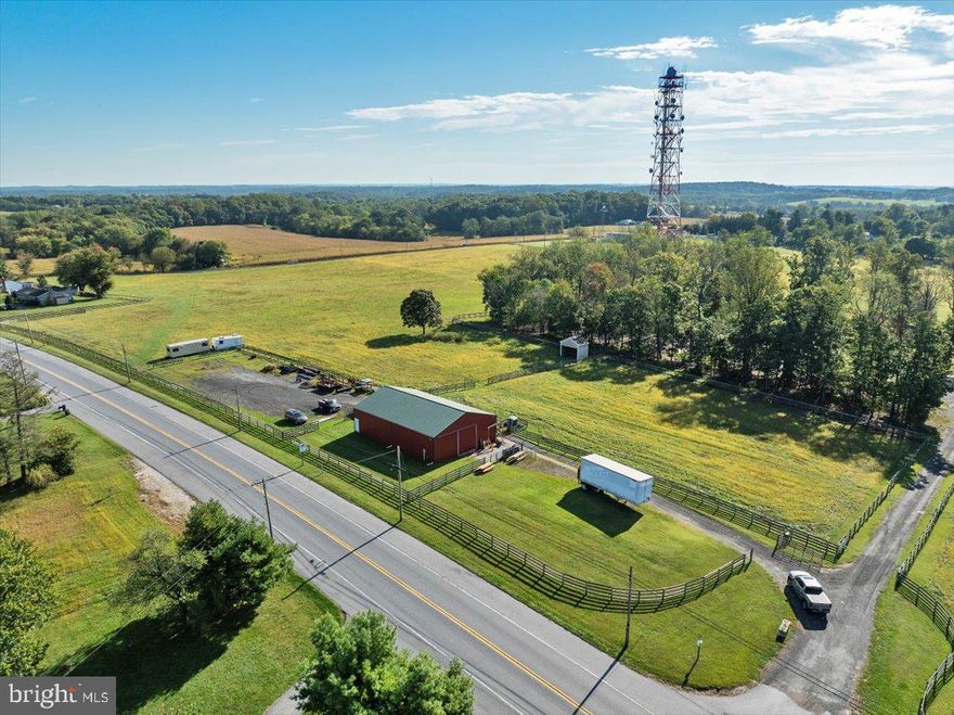 Lease a versatile agricultural building with an adjoining gravel yard along Ridge Road in Mount Airy w/ 27k  cars passing daily. The property features a red metal building with high ceilings, concrete flooring, and wide doors—perfect for storage, workshop use, or agricultural operations. The surrounding gravel area provides ample outdoor storage and easy maneuverability for trucks, trailers, and farm equipment.

Zoned RC-DEO (Rural Conservation Density Exchange Option), this location is ideal for farm-related businesses. Popular permitted uses include produce and farm stands, allowing direct sales of crops or goods grown on-site. Additional permitted and accessory uses may include crop farming, orchards, vineyards, livestock, equestrian operations, and value-added agriculture such as wineries or cideries. With county approval, conditional uses like landscaping contractor operations, mulch/compost production, or other agricultural service businesses may be possible.

Benefit from road frontage and strong visibility in a highly accessible Howard County location. This is a rare opportunity to establish or expand a farm stand, agricultural business, or rural enterprise.
