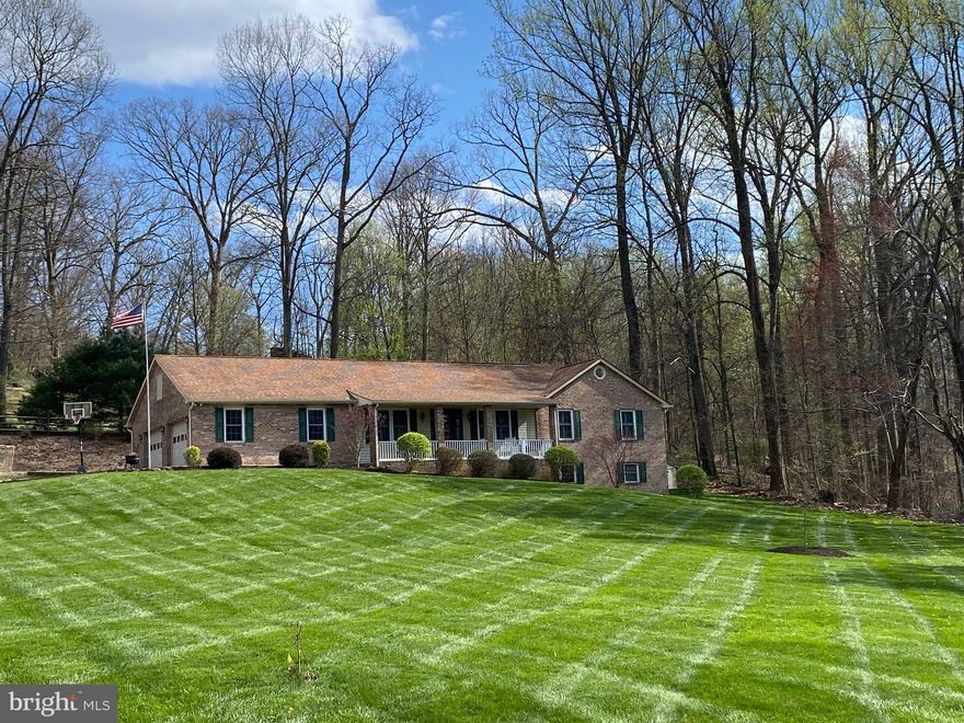 Enjoy one level living in this all brick rancher with 2 car attached garage located on 3 acres. This 3 bedroom, 2 1/2 bath home features open floor plan and has  many updates including granite kitchen countertops and stainless steel appliances.  Large eat in kitchen opens to living room and dining room.  Enjoy working from home in office area located off of foyer.  Lower level offers finished rec room with outside entrance, 1/2 bath, laundry area with plenty of cabinets, and large unfinished space for storage and/or work shop.  Wood stove with brick hearth in basement for additional heating  source.  Large concrete patio located off living overlooking beautifully landscaped rear yard.  Plenty of space for entertaining or hosting family gatherings.