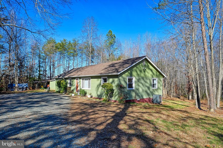 This charming 3-bedroom, 2-bathroom is ready for its new owners. This home blends classic hardwood floors with modern comforts, creating a warm and welcoming space. The property features a newly added 325-square-foot primary suite that includes a private bathroom with a tile shower and a double vanity, and a large walk-in closet. The original hardwood floors flow throughout the main living spaces, while the primary suite offers luxury vinyl plank flooring for a fresh, low-maintenance feel. The second bathroom is accented with ceramic tile for both the flooring and shower.

In the kitchen, all-new appliances are included, offering modern conveniences. The home also benefits from an encapsulated crawl space, contributing to moisture control and energy efficiency. Outside, a large rear deck provides ample space for entertaining and outdoor living, and an outbuilding with an awning adds versatile storage or workshop potential.

Located on four acres, this property delivers privacy, space for activities, and an opportunity to enjoy the outdoors. The ranch layout combines the enduring appeal of original features with the comfort and practicality of thoughtful updates, creating a home that feels both timeless and refreshed.