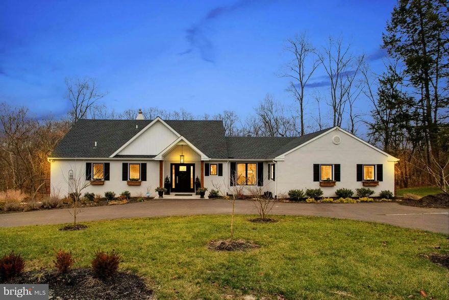 Willow Creek Run is stunning with a sophisticated and modern flair, private, six acres, circular drive, 3-car garage, pond, creek, and a huge deck overlooking the wonderful scenery. This totally remodeled 1965 house is now a “wow” inside and outside. Everything is new. In pristine, move-in condition, it has gleaming wood floors, an abundance of windows (none needing window coverings for privacy), and solid wood doors and kitchen cabinetry in the Shaker style. Taste, style, and full of details, the design, finishes, and floor plan leave nothing wanting. Step through the covered, wide door into a foyer that shows you the heart of this home. Across the rear of the house is a great room that encompasses the dining room and chef’s dream kitchen. The custom kitchen with 42” cabinetry, 8’ island, Quartz countertops, and coffee/serving area is beneath a dramatic 12’ vaulted ceiling. The entire area shares the warmth of a woodburning fireplace, a sliding door opens to the enormous deck, and the dining area views are special in every season. Close by is a huge pantry room and opposite that a laundry/storage room. And then step into the living room with another door to the deck and a sliding one to the side of the house. On the opposite side of the foyer is what makes this house feel like you are living on one floor. A hall leads to a powder room and then to the beautiful main suite. A walk-in closet with a window and two other closets give you plenty of space. The ensuite bathroom has a double vanity, a large shower, mosaic tile decorative floor, linen closet and window that does not need covering. Amazing, isn’t it? The second floor is where you feel like you are living in a treehouse because of the rear elevation. There are three bedrooms, one could be an office, a double hall closet with another laundry hookup, and a hall bathroom with a tub/shower. The largest bedroom has a triple and single window…and incredible views. There are three levels (all above grade) in this extraordinary home. The lower, walk-out level is a large multi-purpose room for your lifestyle. Family room, media room, recreation room…whatever you want. A door opens out to a gravel area underneath the deck and large windows provide light. Outdoors is amazing and the setting makes this house one to enjoy in every season. Besides the 50’ x 12’ deck, an outdoor extension for relaxing and entertaining, there is a 6-person hot tub, woods and evergreen trees, the pond and a winding creek. Wildlife come to visit below and birds will delight you. Gracious living in a serene setting, here the living is easy. Low taxes and the best of everything…a 2-year old home with high quality materials, products and craftsmanship, close proximity to I-95 and surrounding Bucks County attractions, and your very own extraordinary haven that will welcome you each time you return. Visit WillowCreekRun.com for full tour