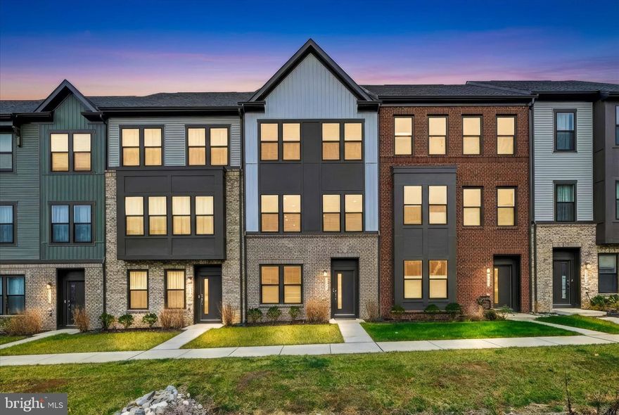 Immaculate and luxuriously appointed, this three-level Frankton model townhome in the prestigious Watershed community offers the benefits of nearly new construction without the wait. Only one year old—and with the builder’s one-year punch-out list recently completed—the home shows exactly as it did the very first day the sellers moved in. Every space feels pristine, polished, and lightly lived-in, making it truly move-in ready for the next fortunate owner.

The entry level offers a beautifully appointed private suite complete with a large bedroom and its own full bath, making it ideal for guests, multigenerational living, or a dedicated home office. The foyer presents a stylish welcome with contemporary metal stair spindles that elevate the home’s interior aesthetic. The oversized two-car garage includes an interior Level 2 EV charger on dedicated 50-amp circuit and provides exceptional storage and convenience.

The main level features an expansive open-concept design ideal for both elegant entertaining and relaxed everyday living. The stunning gourmet kitchen serves as the centerpiece of the home, offering premium stainless steel appliances, an oversized quartz island, contemporary pendant and recessed lighting, upgraded cabinetry, and generous prep and storage space for the most discerning chef. The adjoining café area and spacious living room flow seamlessly together, creating an inviting atmosphere filled with natural light. Just off the kitchen, a large composite deck extends the living space outdoors—perfect for morning coffee, evening gatherings, or quiet relaxation.

The third level hosts the luxurious owner’s suite, which spans the rear of the home and offers a serene private retreat complete with two generous walk-in closets and a spa-inspired bath featuring an oversized walk-in shower and refined finishes. This level also includes two additional spacious bedrooms, a well-appointed full bath, and a conveniently located laundry area—creating a highly functional layout for today’s modern lifestyle.

Set within the highly sought-after Watershed community, this residence offers access to exceptional lifestyle amenities and a naturally beautiful backdrop adjacent to the Patuxent Wildlife Refuge. Residents enjoy a state-of-the-art clubhouse with fitness and wellness spaces, co-working areas, and social lounges, as well as an outdoor pool, dog parks, playgrounds, community gardens, and miles of scenic walking and biking trails. The community’s meticulously maintained grounds and contemporary design create a luxurious environment that feels both modern and tranquil.

Watershed is centrally located near premier shopping, dining, and essential commuter routes. With quick access to Routes 32, 295, 100, I-95, 495, and 50, this home offers a highly convenient commute to Washington, D.C., Baltimore, Annapolis, BWI Airport, Fort Meade, NSA, NBP, DISA, US Cyber Command, and other major employment centers.

This pristine, beautifully upgraded townhome combines luxury, comfort, and an unbeatable location—making it an exceptional opportunity in one of Anne Arundel County’s most desirable communities. Seller will pay the first year of HOA dues for any accepted offer received by December 19, 2025, at 5:00 PM. Schedule your private showing today! Open House: Saturday, 12/13/25 from 12–3 PM. Come by and tour this fabulous property!