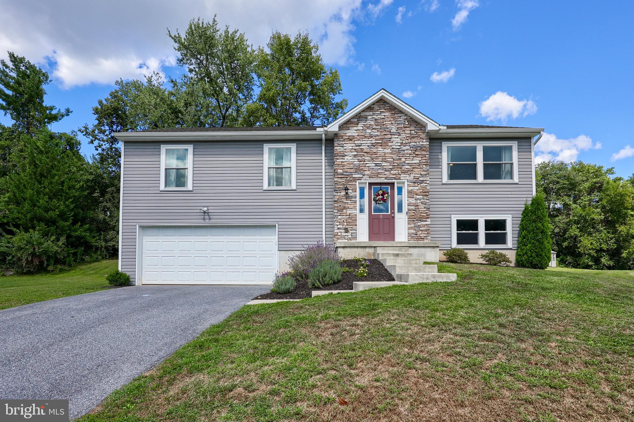 Welcome home to a beautiful bi-level offering over 2000 square feet of thoughtfully designed living space. Built with comfort and convenience in mind, this open-concept home offers three bedrooms and two full bathrooms. The primary suite includes a private bath, creating a comfortable retreat. Features worth mentioning: main level cathedral ceiling in an inviting living room, a kitchen with an island and dining area with access to the deck that is perfect for gatherings or a cozy start/finish to your day. The lower level provides a spacious family room, ideal for relaxing, working from home, or whatever your heart desires. Situated on nearly half an acre at the end of a quiet cul-de-sac, you’ll enjoy both privacy and a peaceful setting. A two-car attached garage and generous storage space add to the appeal. With a modern design, a desirable location, and convenient access to commuter routes, schools, shopping, and dining, this home is ready to welcome its new owners.