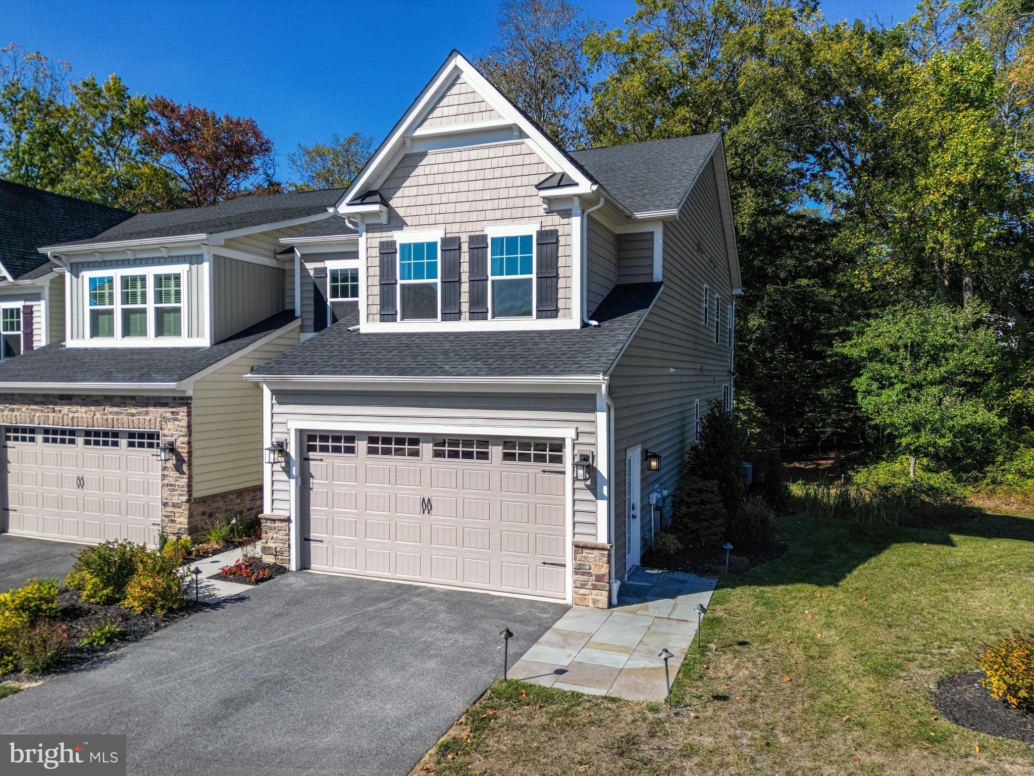 Welcome to Ponds Edge, a premier executive - style townhome community in Media Pa. This stunning end unit, 2 level townhouse with a fully finished walk-out basement and a full bath, was the builders model home, designed to showcase the highest quality upgrades, premium finishes and designer touches. Never lived in and move-in ready, this home sits on one of the best lots in the community, offering a private wooded backdrop and unparalleled elegance. No need to wait for your home to be built! This sunny end unit features 4 bedrooms and 3.5 bathrooms and a 2 car garage. Premium Designer Hardwood flooring throughout (no carpet) along with a private end unit location. Step into a welcoming foyer and a spacious flex room, ideal for formal dining or a home office and adorned with an accent wall with grid pattern molding and a full LED recessed lighting package. This Northshire Model features an open concept floor plan, perfect for entertaining. The gourmet, eat-in kitchen includes upgraded cabinetry, 5 burner cooktop, an oversized island with quartz countertops and a full stainless steel chef’s appliance package. The sophisticated family room features a gas fireplace with recessed lighting and gorgeous designer inspired wainscoting. Adjacent to the kitchen is a cozy breakfast area and walk out deck offering stunning wooded views from the 2nd story main floor. A mudroom with cubbies, a half bath and an attached 2 car garage with electric openers complete this floor. The upper level has 4 spacious bedrooms highlighted by an owner’s suite with tray ceiling, custom recessed lighting and designer drapery. A spa-like ensuite bath with dual vanities, upgraded fixtures, oversized walk-in shower with a bench, 2 shower heads and floor to ceiling artisan tile. There are three additional spacious bedrooms that share the hall bathroom with double vanity and tub/shower combo. A convenient second - floor laundry room rounds out a long list of luxury features found on this level of living. This move-in ready designer home is packed with extras to include washer, dryer, refrigerator and designer window treatments. A built in multi-zone irrigation system is complimented by energy efficient features and high end finishes throughout. The prime location & community perks include a Community Center, playground and walking trails. Just minutes from the "Wawa Septa Station" that provides ultra convenient access to Center City Philadelphia. In addition, you are close to The Shoppes of Brinton Lake, The Promenade at Granite Run and the Top Rated Media restaurant scene. This former builder's model home is an exceptional opportunity - fully upgraded, never lived in, and available now! Schedule your private or virtual tour today - this one won't last.