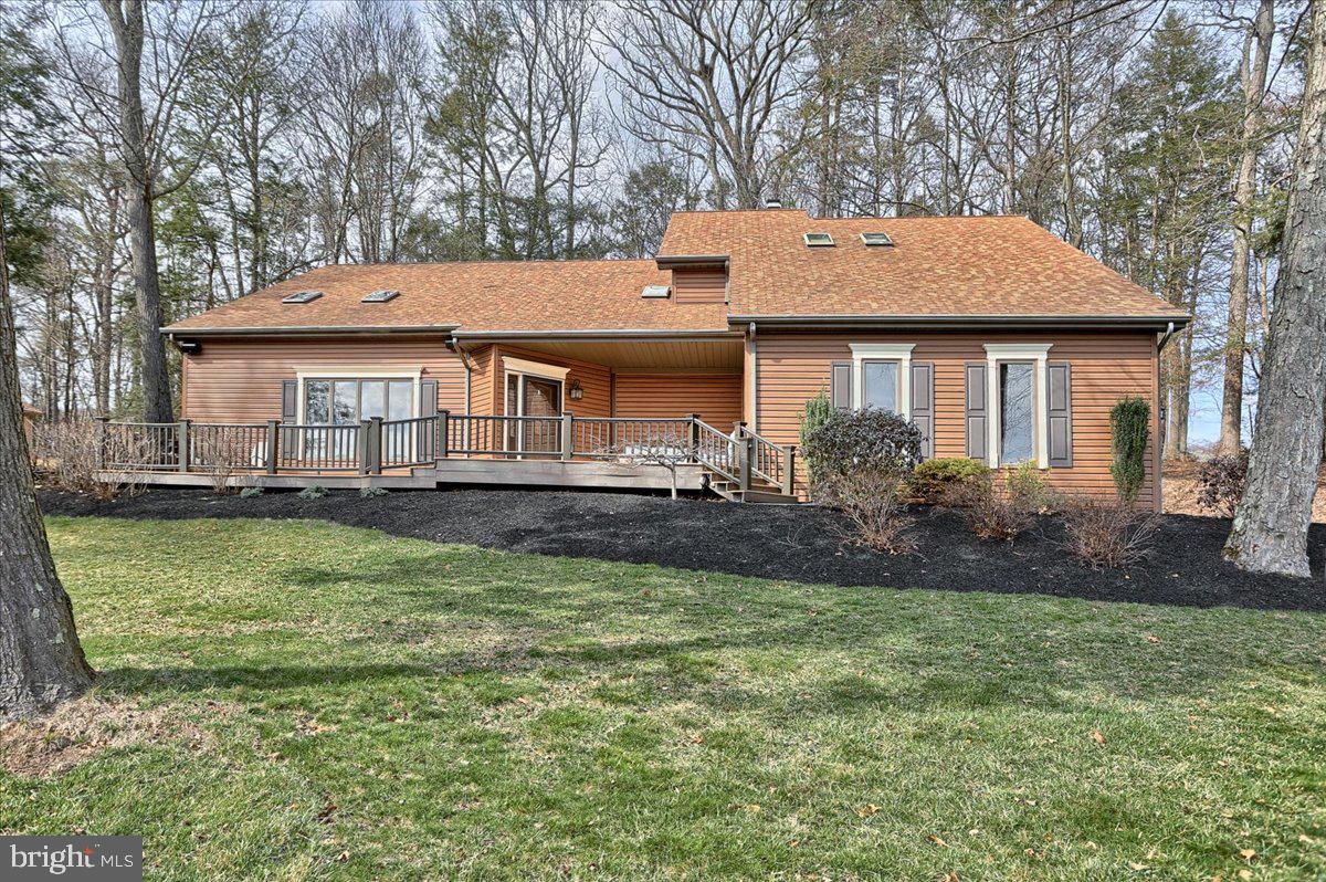 Breathtaking four-season views of the Blue Mountains... from almost every window in the house!  This beautifully crafted and well maintained custom contemporary home, built by Custer Homes, features 3 bedrooms, 2.5 bathrooms, 2,584+ sq. ft. (it FEELS like more!) and is situated on a 1.08 acre wooded and private lot! As you enter through the front doors, you'll be greeted by a vaulted foyer and living room with skylights, a gas fireplace with mountain stone, built-in shelving and stunning mountain views. Just through the living room, you'll find a spacious dining room with French doors that lead to a large, 45-foot wood deck with a path to the driveway and stairs to the rear of the property. The gourmet kitchen features a large wraparound island with Quartz countertop, undercabinet LED lighting, stainless steel appliances, a built-in microwave, wall oven, a double-bowl sink and a built-in desk area and wine rack. Next to the island, you'll find a cozy breakfast nook that is filled with natural light and beauty. The kitchen is open to the family room which features a second wood burning fireplace with a marble surround, built-in bookshelves, and a sliding glass door that gives you additional access to the rear deck. Down the first floor hallway, you'll find a half bathroom and the first of 2 office/flex spaces; this one doubles as a laundry room and includes the washer and dryer, but could be a study, fitness room or even a 4th bedroom. Up the staircase to the second floor, you'll first enjoy an open loft that is perfect for that second work-from-home office, guest space, or sitting area. The master suite features a large bedroom, a sitting area, a double walk-in closet with pocket doors,  a spacious, contemporary bathroom, and built-in makeup vanity. There are two additional bedrooms on the second floor with another full bathroom. The side entry, 2-car oversized garage with polyaspartic flake floor has extra storage room with a separate entrance. Enjoy entertaining or cooking out on your expansive 40-foot long Trex composite front deck with a built-in sound system and a stunning view of the Blue Mountains! There's an unfinished basement that is roughed in for an additional bathroom and has a radon remediation system. Other features include an energy efficient HVAC system and 80 gallon hot water heater (both replaced in 2016), wiring for a generator (existing generator not included) and gutter guards. Ideally located north of Harrisburg and Linglestown in the Central Dauphin School District, it's an easy 15-20 minute drive to the state Capital. It's 6 miles to scenic Fort Hunter on the Susquehanna River. In only 15 minutes, you can get to Hollywood Casino and Penn National Racetrack and 20-25 minutes away is Hershey and all the Hersheypark attractions. Fishing Creek Estates has access to hiking trails, state game lands and the nearby Boyd Big Tree Preserve. There are so many upgrades and features in this home, you simply need to see it to believe it. Be sure to read the additional information provided by owners, which is available online.  Did we mention the views?
