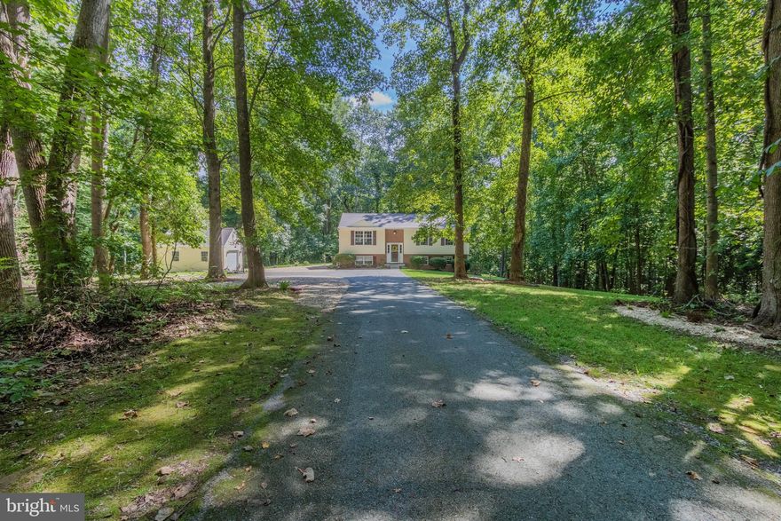 Beautiful, meticulously maintained home on 4.5 Acres! Main level features 3 bedrooms and 2 full baths, family room and eat-in kitchen with black leathered granite countertops and stainless steel appliances. Tile backsplash accents the kitchen and kitchen island. New hardwood flooring throughout main level and tile floors in master bath and hall bath. Lower level has tile flooring throughout, carpet in the 2nd family room area, a 4th bedroom, full bath and laundry room with folding area. Relax on the large deck that runs the width of the house or at the fire pit in the back yard. Detached one car garage/workshop with electric and attic storage. Bring the dirt bikes, ATV's and boat. Plenty of room for riding on the large wooded lot and only 3 miles from Goose Bay Marina! No HOA! New roof and gutters (2019), sump pump (2020), hardwood floors (2020), AC unit (2018), well pump (2019), septic pumped (2019). Qualifies for 100% financing through USDA (if eligible). Hurry up and schedule a showing, this will not last long!