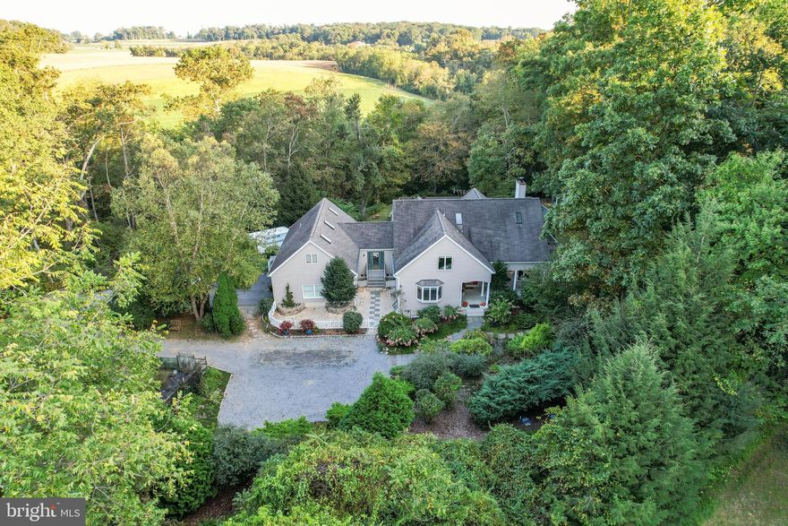 ****Welcome to 5801 MOUNT GILEAD RD!  In any season, this location could not be more picturesque. The wooded hills, seclusion and serenity – this is what Maryland is all about! Mark Beck (Beck, Powell, and Parsons) designed home with open floor plan, southern light-filled exposure and Anderson/ Art Glass windows overlooking premium tranquil views.  You'll love outdoor entertaining with the gazebo, patio, and pergola!  But this 6.11 acre pet friendly slice of heaven is located in such a convenient location, too. Only 5 minutes to the route 140 entrance, or a few minutes more to the 795 entrance. After you fall in love with the location, you’ll fall in love with the custom home, too. Step through the front door of this home, into a vaulted ceiling  living room gleaming hardwood floors throughout. A formal dining room overlooks the park-like front acreage. The kitchen features all the bells and whistles that the chef inside of you yearns for with  a large upgraded countertop and room for table seating as well. Fantastic open floor plan means that you’ll always be part of the party. The great room has a floor to ceiling mantled ash wood fireplace . Through the great room deck doors awaits stunning  views of the back yard featuring a unique croquet court  The primary suite is located on the first floor with a huge walk-in closet and en-suite bathroom spacious soaking or spa tub and bidet.  Large upstairs bedrooms features a three closet alcove and spa bathroom, third bedroom has a separate bathroom. Back on the main floor, there is a large laundry room/butler's pantry,  Downstairs is a huge basement with resistance pool, and wood shop that can fill all of your needs for storage, extra living room or both!  Extensive driveway and parking areas mean you can throw large parties with space for everyone's cars. This home is a MUST SEE!!!!