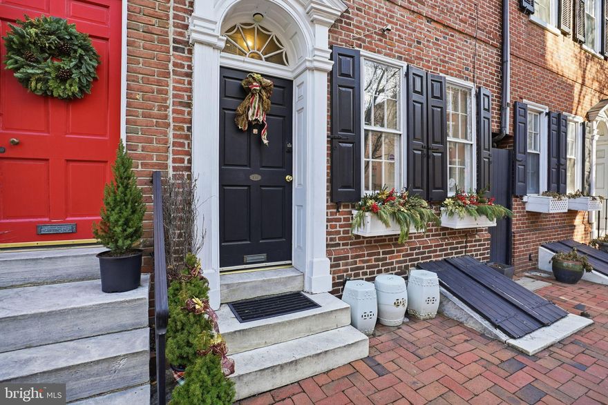 Step into historic Philadelphia charm blended seamlessly with modern comfort in this beautifully appointed three-bedroom, two-and-a-half-bath brick townhome on one of Philadelphia's most sought-after streets in the heart of cherished historic SOCIETY HILL. Spanning approximately 2,560 square feet, this residence delivers character, space, and multiple private outdoor retreats—an increasingly rare find in the city.

From the moment you enter, exposed brick walls, warm hardwood floors, and classic architectural details create an inviting atmosphere that honors the home’s historic roots while embracing today’s lifestyle. The main level offers an open and flexible layout ideal for entertaining, featuring generous storage and elegant French doors that lead to a private, tree-lined courtyard—perfect for alfresco dining or quiet evenings outdoors.

The charming lower level is where the home truly shines, anchored by a striking chef’s kitchen with soaring ceilings, rich red tile flooring, and a cozy gas fireplace. Custom cabinetry, granite countertops, and quality stainless steel appliances—including a Bertazzoni gas range and Bosch dishwasher—make this space as functional as it is impressive. Contrary to the commonly small townhouse kitchens, this part of the house offers, aside from a breakfast bar, an adjacent dining area with enough space for a large dining table,   as well as brick arches, offering additional seating for 8, the perfect place to accommodate even larger crowds.  The gas fireplace and the exposed beams add warmth and character.  A conveniently located powder room completes the level.

Up the stylish spiral staircase, the entire second floor is dedicated to the owner’s suite, offering a peaceful retreat from city life. The spacious bedroom features a wood-burning fireplace, a custom walk-in closet, and a spa-inspired en suite bathroom with a glass-enclosed rain shower and expansive vanity. Just beyond,  a large, peaceful private roof deck provides the perfect setting for morning coffee or evening relaxation under the city skyline. An ambicious gardener could turn this spacious place into a fabulous roof garden.

The top floor includes two additional generously sized bedrooms, one with its own fireplace, along with a full hall bathroom—ideal for guests, family, or home office needs.

Situated in one of Philadelphia’s most desirable neighborhoods, this home is moments from beloved green spaces, historic landmarks, vibrant dining like the Michelin star french restaurant - Provenance, - or Steven Starr's STELLA. For nature Lover's, the new huge Park at Penn's Landing - still under construction-  and the Delaware River are 5 walking minutes away.
 Or walk just across the street on a Sunday morning to shop for farm-fresh delicacies at the iconic Headhouse Farmers Market.  boutique shopping.  With easy access to public transportation and exceptional walkability, this classy Society Hill location offers the best of city living right outside your door