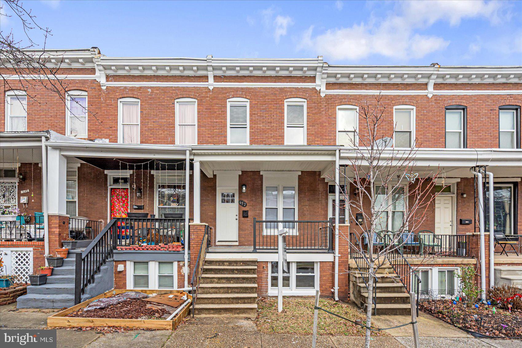 Beautifully remodeled 4BR/2BA classic brick Baltimore Townhome located on a tree-lined street. Step up to the covered front featuring new railings and open the door into your forever home. Step into an open concept floor plan offering tons of natural light, easy care flooring, and a warm color pallet. The main floor offers a large living room, spacious dining area, and a stunning kitchen. The kitchen features mixed metals featuring stainless and gold accents, plenty of cabinets, a large walk-in pantry, stainless steel appliances including a slide-in gas range, sleek quartz countertops with a complimenting tiled backsplash, a stainless sink set into a spacious island featuring pendant lighting, waterfall edges on both sides, and breakfast seating for three or more. On the second floor is a large primary bedroom, two sizable secondary bedrooms, and a beautifully remodeled full bath. The lower level offers additional living space featuring the fourth bedroom, a new full bath, above grade windows, a large family room, storage, laundry, and a walk-out to the fenced yard. From the kitchen step outside to a yard filled with tons of possibilities or off street parking. This home is move-in ready with so much to offer new homeowners and is located in close proximity to shopping, restaurants, and commuter routes.