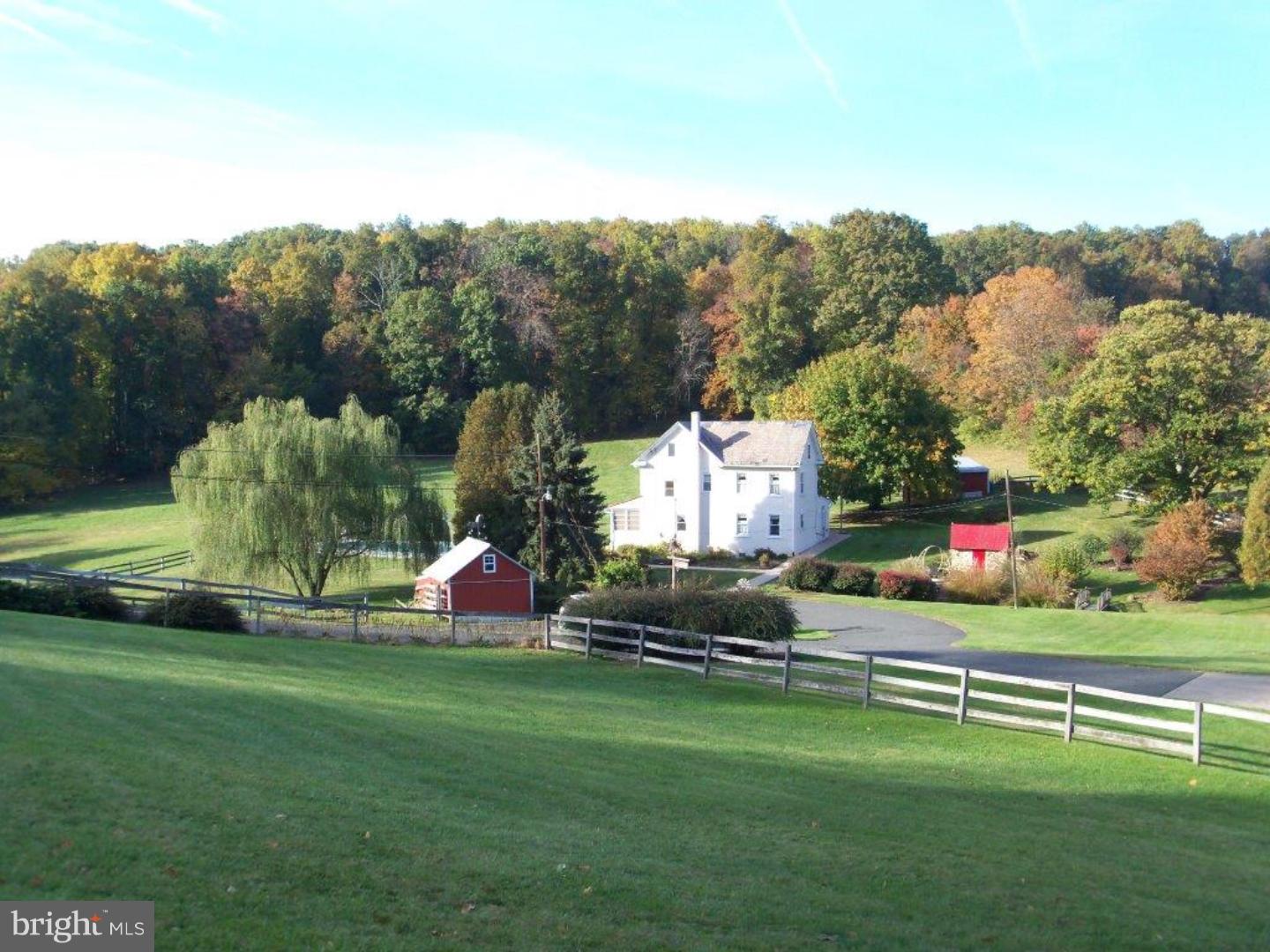 Own a piece of history with this 1800's stucco over stone farmhouse which sits down in the valley on over 6 acres! The location and setting for this property are breathtaking and you will love all the outbuildings.  Starting with a large barn that incorporates a 4 car garage, 6 stalls, tac room, bunk house and lots of storage.  There is also a spring house(which feeds the stream), smoke house, pig pen, utility shed and outhouse.  The home itself has lots of potential and features replacement windows, newer oak kitchen with laminate flooring and a den which opens into the sun room with built in hot tub.  Also located on the main level is a master bedroom that was recently added (it used to be a second living room) that has a full bath and walk in closet.  A great feature or you can turn it back into a living room. Upstairs are 3 additional bedrooms and another full bath.  The home also has a walk up attic and full basement along with an enclosed porch that overlooks the Fronheiser inground pool. Again, the setting is incredible so don't delay!  This one won't last long.