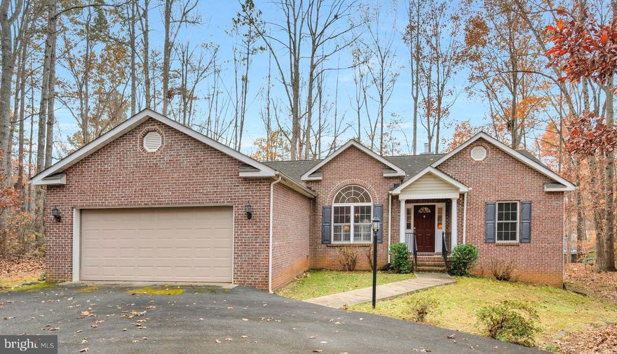 Welcome home to 111 Carriage Court! This wonderful brick front home located close to the main gate and in a private cul-de-sac will be the one. Once you enter, you are welcomed by gleaming hardwood floors, a great room with brick fireplace and soaring ceilings. The kitchen boasts plenty of counter space to spread out, as well as a breakfast bar and a dining area! The sunroom off the family room will be one of your favorite areas with access to the deck. When it comes to entertaining family and friends, the formal dining room and flow of the main living areas are sure to please. The inviting owner's suite is spacious, and the en-suite bathroom offers a double vanity and soaking tub with jets. Two additional bedrooms, full bath and laundry room complete the main level. Enjoy your favorite beverage, read a book, or take in the sounds of nature from the deck. A private, gated, secured community, Lake of the Woods offers anything and everything you could possibly want. Home to two lakes (the 550 acre main lake and a 35 acre "fishing lake"), a golf course, an equestrian center, a fire and rescue department, and a church all within the gates, Lake of the Woods simply has it all. Whether your passion is boating, water skiing, kayaking, golfing, horseback riding, or simply taking in the breathtaking views from the clubhouse while enjoying a fabulous meal, from your own deck or yard, or from one of the beaches, you won't be disappointed! Perhaps you'd like a game of bridge or volunteering your time and talents...Lake of the Woods offers more than 60 clubs and/or organizations from which you may choose to become involved. Located in Orange County, we are fortunate to enjoy low real estate taxes. Coupled with home prices ranging from $200,000+ to over $2,000,000, Lake of the Woods is the perfect community for both full-time residents, as well as weekenders. But don't take my word for it, please come see for yourself! I will gladly give you a tour of Lake of the Woods by boat and by car so that you may experience why I love Lake of the Woods!