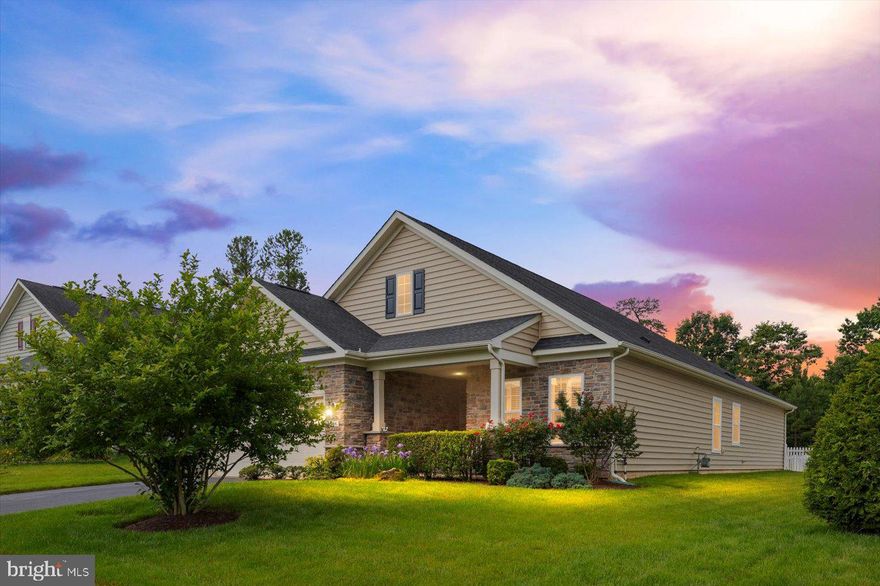 Nestled in one of the region’s most vibrant senior living communities, this beautifully maintained home offers a perfect blend of luxury, functionality, and peace of mind. From the inviting front porch and stone-accented façade to the rich hardwood floors and elegant crown molding inside, every detail was thoughtfully designed for easy, graceful living.

The versatile floor plan includes a formal office (or optional bedroom), a spacious great room with a cozy corner fireplace, and a stunning kitchen featuring 42” cabinetry, a gas cooktop, wall oven, and an oversized island—perfect for entertaining. The primary suite is a true retreat with two walk-in custom closets, a tray ceiling, and a spa-like bath with a soaker tub and separate tiled shower. Enjoy evenings on the concrete patio in your private, fenced backyard oasis.

But the home is just the beginning—residents here enjoy access to an impressive 18,000 sq. ft. clubhouse offering a grand ballroom, billiards, card rooms, a library, fitness center, and dedicated activity spaces. Dive into wellness with indoor and outdoor pools, group exercise classes, and a steam shower and sauna for post-workout relaxation.

Outdoor lovers can explore walking trails, play a match on the tennis or bocce courts, or gather with friends for a game of horseshoes. With on-site staff, a community website, and clubs galore, you’ll always be connected, active, and inspired.

Whether you’re hosting grandkids at the tot lots, joining a fitness class, or enjoying a book in the library, life at Virginia Heritage is rich with opportunity. Welcome home!