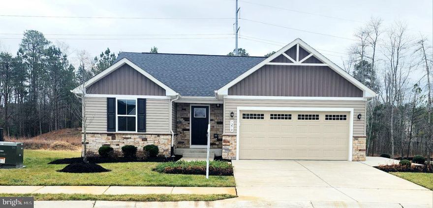 Welcome home to this Grand Bahama model home nestled on a beautiful lot within the highly sought-after golf course community of Pendleton in Caroline County. Conveniently located minutes from I-95  and Route 1, this model home offers gorgeous luxury upgrades. While walking up, you'll be welcomed by a meticulously manicured lawn and exterior of the home, complete with in-ground irrigation system, front flower bed up-lighting, stone facade, and separate side garage entrance. If entering through the garage, you'll notice finished walls, a custom epoxy coated flooring, additional storage space, garage door openers, as well as a mini split HVAC to separately heat and cool the garage. If entering from the front door, you'll be welcomed into an inviting foyer, complete with luxury vinyl plank flooring and alarm system panel. To the left, you'll see two guest rooms and a hall bathroom. To the right, you'll find access to the unfinished basement which has a semi-finished storage room, full bathroom rough in, as well as additional electrical outlets. As you walk to the main living space of the home, you'll find a great room. The kitchen, dining, and family rooms are all open to each other, making for great sight lines, perfect for entertaining as well.  Off the dining area is a sliding door where you can add access to the beautiful private back yard. The gourmet kitchen is a cook's dream with stainless steel appliances, granite countertops, an island, and a large pantry. Also in the back of the home, you'll find the luxurious owners' suite, complete with a large walk-in closet and bathroom. The bathroom has double sinks and a tiled shower stall with glass doors. You don't want to miss this gorgeous model home! The community offers top-notch amenities, including a pool, dog park, tot  lots, walking trails, sports courts, and trash pick up all covered by the HOA. Golf enthusiasts will love the discounted fees at Pendleton's very own 7,000-yard golf course designed by the Gary Player Design Company. Schedule your showing now to take advantage of an opportunity to own a home in one of Caroline County's finest communities.