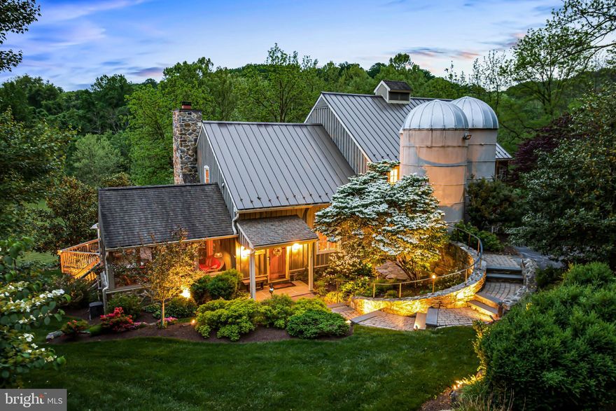 Showings begin 4/3 at noon.

Welcome to this one of a kind masterpiece designed by Bruce Cavin and meticulously built for the current owners by Mike McCorkle in 2008. This breathtaking, four-story stone residence is sited on a spectacular 10-acre parcel where a former bank barn was once located , artistically incorporates two previously existing 40 foot silos that were left in place, and offers a sun-filled open floor plan, soaring ceilings, incredible millwork and floors, fabulous indoor and outdoor living spaces and endless private vistas of the glorious grounds, gardens, walking trails, stream, pond and protected Brandywine Conservancy surroundings  at every turn. Endless custom features and amenities include high efficiency and cost saving geothermal systems, a welcoming foyer which immediately provides sightlines of the expansive great room windows, serene screened porch with babbling waterfall and open exterior deck, open living, dining room and gourmet kitchen, office, sunny first floor primary suite with large bedroom, walk-in dressing room and luxurious marble bathroom, adjacent first floor laundry room, 3 stop elevator, second floor   loft/ flexible bonus room area, 3 large second floor bedrooms with two additional full bathrooms (one is en-suite), enormous ground level bonus room with powder room, 2-4 car oversized garage/ woodshop spaces and 2 original restored silos which would make a jaw dropping wine room or added library room. The possibilities are endless! This charming, artistically designed Chester County treasure is in absolute move-in condition and awaits its next luck stewards. Close to all that West Chester and the surrounding area has to offer and LOW TAXES!