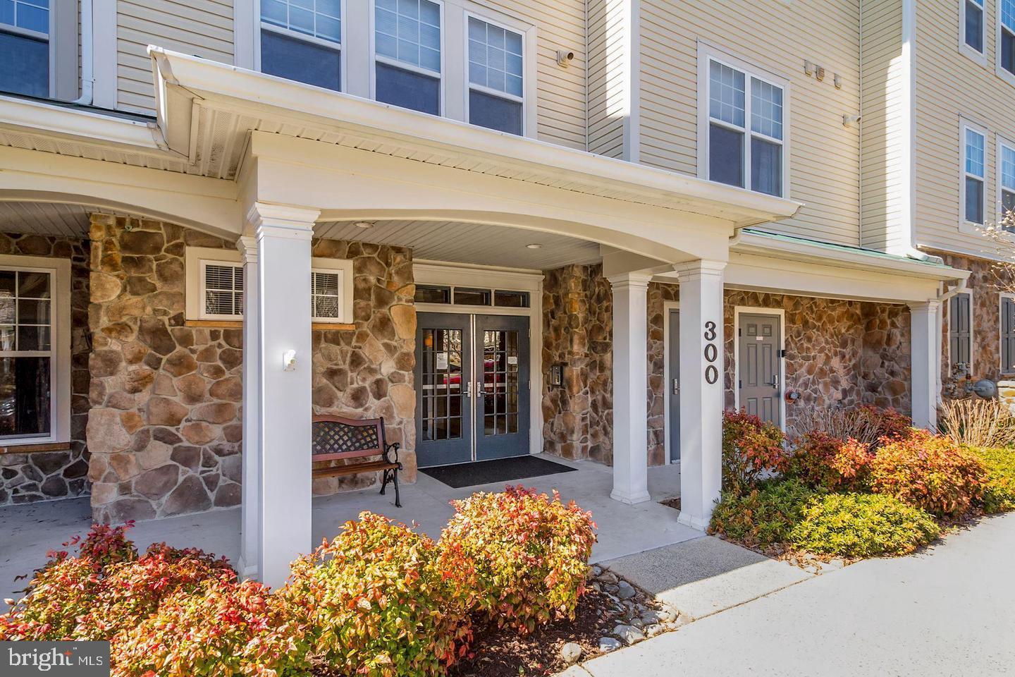 Welcome to this stunning and rarely available upper-level corner unit offering 1,729 sq. ft. of luxurious living space in one of the most private, wooded, and peaceful locations in the community. This beautifully updated 2-bedroom, 2-bath home features an open and light-filled layout with gleaming hardwood floors, a cozy gas fireplace, and a spacious living and dining area that flows into a bright sunroom—perfect for a home office, reading nook, or simply enjoying the tranquil views. The modern kitchen is a chef’s dream with sleek countertops, stainless steel appliances, and ample cabinetry, combining functionality and style for everyday living or entertaining. The serene primary bedroom includes two oversized closets and an en-suite bath, while the generously sized second bedroom also offers a large closet with built-in organizers and easy access to the second full bath. Additional conveniences include in-unit laundry with a full-sized washer and dryer, an attached garage, and additional storage. Residents enjoy access to community amenities such as a pool, clubhouse, and fitness center, all while being minutes from shopping, dining, and entertainment. This exceptional home offers the perfect blend of space, comfort, and serenity—truly a rare find.