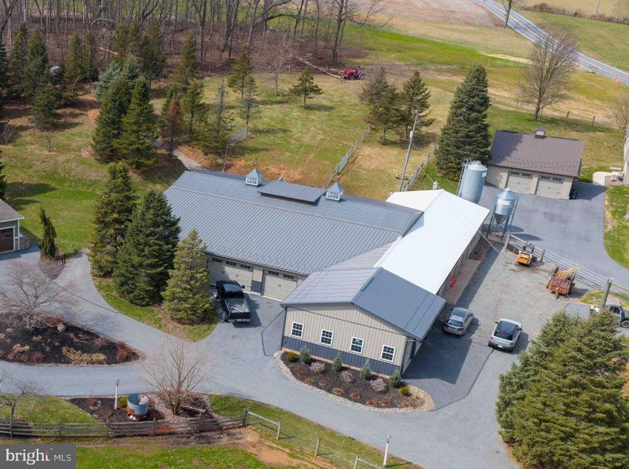 The property is exceptionally well-equipped for agricultural or commercial business use with an extensive multi-section barn and shop complex (approx. 7,800 sq,ft) including:-----30’ x 25’ garage/shop with (2) 8’x9’ overhead doors----29’ x 88’ shop / barn section with (3) 8’x9’ overhead doors-----60’ x 55’ shop structure with (5) roll-up doors------21’ x 61’ shop section with (2) overhead doors (8’x14’ and 8’x10’) -------Private two home estate combines quality construction with fully developed commercial / agricultural infrastructure on 10+/- acres.---------The custom-built home (2013) offers over 4,800 sq ft above grade with four bedrooms and five bathrooms, plus a finished lower level featuring an additional bedroom, a living area, and 10’ ceilings. The home reflects estate-level construction with generous scale, quality materials, and thoughtful design throughout. Additional features include 9’x8’ overhead doors in the three-car attached garage, and a seamless connection to outdoor living anchored by a large flagstone patio with chimney hearth. --------A second full residence provides three bedrooms, two bathrooms, and a two-car detached garage—ideal for multi-generational living, guest accommodations, or on-site management.   Additional improvements include a large bank barn, multiple run-in sheds, fenced pastures, greenhouse, and chicken coop—supporting equestrian, livestock, or small-scale farm operations.------A standby propane generator system services both the main residence and shop, supported by two 1,000-gallon buried propane tanks, providing reliability and long-term utility.--------A rare offering where custom residential quality, multi-dwelling flexibility, and turnkey agricultural/ commercial infrastructure converge—creating a property that would be difficult to replicate at today’s construction costs.  --Buyer Must Check Zoning Use with Township.