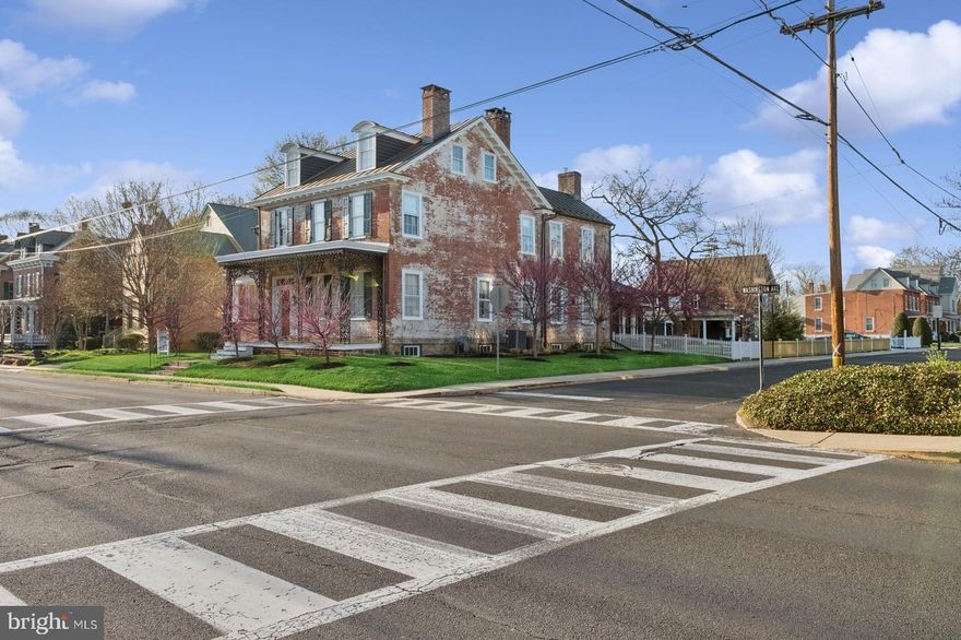 Timeless Elegance Meets Everyday Living in This 1837 Georgian Masterpiece in Newtown Boro

Step into history with this remarkable, fully restored historic home, originally built in the 1830s by Joseph Archambault, a French Napoleonic War veteran and one of Newtown's most fascinating figures. Archambault played a pivotal role during the American Civil War, where he mustered a cavalry and attained the rank of Major. Nestled in the heart of Newtown Borough, this stunning 5-bedroom residence offers a rare blend of timeless elegance, meticulous craftsmanship, and modern luxury.
From the moment you arrive, the classic curb appeal and commanding brick exterior hint at the home’s rich heritage. Inside, 10-foot ceilings, five fireplaces, and original wide-plank pine floors speak to the craftsmanship of the 19th century, while generous proportions and updated features make the space truly livable for today’s needs.

The layout is both traditional and functional, beginning with a formal living room and an elegant dining room that invite you to entertain in style. Each space showcases original millwork, fireplace surrounds, and period details that whisper stories of generations past. The sunroom—bright and inviting—is perfect for morning coffee or quiet reading.

The heart of the home is the spacious eat-in kitchen, where character meets convenience. A wood-burning stove adds warmth and charm, while stainless steel appliances, upgraded countertops, and a center island provide everything a modern cook needs. Whether hosting a gathering or enjoying a quiet evening at home, this space blends function and ambiance seamlessly.

On the next two levels, you'll find five generously sized bedrooms and a thoughtful layout that balances privacy and accessibility. The primary suite offers a peaceful retreat, featuring an en suite bathroom with double vanities, a makeup station, double closets, and custom built-in dressers. The second floor also includes a convenient laundry area—rare for a home of this vintage.

Outside, the fenced yard is a private oasis. Mature landscaping and a garden shed enhance the space, offering both convenience and utility. One of the property’s most unique features is the two-story carriage house, once a horse barn, now brimming with potential. With a stunning copper roof, full crawl space, and exterior bulkhead, it’s ideal for a workshop, studio, or future guest quarters. The carriage house has it's own electric, sewer and gas hookup. Zoning council approval was previously obtained to make the carriage house a single family home, which could produce excellent rental income. 

The carriage house and shed are connected by a breezeway, which was previously a one car garage and could easily be converted back to such, if a new homeowner would need.  
 
Additional features include a full basement with ample storage, original details throughout, and architectural elements that have stood the test of time. Every room has been lovingly maintained, with careful attention to preserving the home’s legacy while allowing for today’s lifestyle.  Custom window treatments, 19th-century light fixtures, and restored hardware enhance the home’s elegance.

Best of all, this exceptional property is located just steps from the best of Newtown Boro—award-winning restaurants, charming boutiques, cultural attractions, and community events are all at your doorstep. Situated in the highly acclaimed Council Rock School District, this home offers not just a residence, but a rare opportunity to become a steward of local history.

Whether you’re a lover of architecture, a preservationist at heart, or simply someone seeking a home with soul, this 1837 Georgian treasure is unlike anything else on the market. Schedule your private showing today and experience the magic of Newtown Boro living.