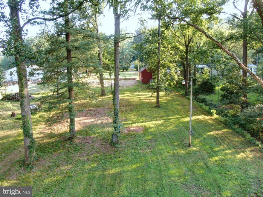 Versatile Creekfront Lot in Northern York School District. Discover a rare opportunity to own a beautiful and private 0.82-acre lot with direct frontage on the scenic Conewago Creek. Situated in the desirable Northern York School District, this level property is a perfect canvas for your dream retreat. The lot is primed and ready for your vision, featuring essential infrastructure that saves you time and significant expense. It is already equipped with a well, a sand mound septic system, and active service from Adams Electric. A large shed provides ample storage for tools and recreational gear, and a solid concrete pad is already in place. Surrounded by mature trees that enhance its seclusion and natural beauty, the property also features a charming, small spring-fed stream running through it. This land offers ultimate flexibility: you can build a custom home, perhaps place a mobile home, or park your RV for the perfect waterfront lifestyle. This is a unique opportunity to create your ideal getaway with the perfect blend of serenity, privacy, and convenience.