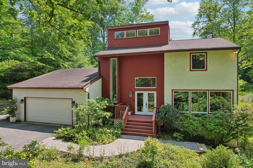 Tucked away in a peaceful woodland setting complete with babbling brook, this custom-built contemporary home offers a seamless blend of French country and natural beauty.  Boasting four spacious bedrooms and three and a half well appointed baths, this home is thoughtfully designed for comfort and style. 
Step inside to a soaring foyer, polished parquet floors and expansive floor to ceiling windows that flood the interior with natural light while framing breathtaking forest views. The main level of the residence features a gourmet kitchen with large island,  carefully chosen decorative tiles from Italy, a spacious dining area, and a cozy yet refined living room centered around a wood burning fireplace - perfect for gatherings or quiet evenings at home. Rounding out the first floor amenities is a wonderful three seasons enclosed porch. Enjoy serene views and indoor/outdoor living nearly year round in this most welcoming space.  Upstairs the primary suite is a private retreat, complete with a beauty bar, spacious closets, stunning views and private deck with a two person hot tub.  Additional bedrooms offer flexibility for guests, a home office, or a growing family.  The finished walk-out basement is chic and provides an additional living space with optional fifth bedroom or flex space and full bath. A creative and comfortable place for family game nights, reading or gathering around the fireplace this space is warm and inviting.  The sliding glass doors offer yet another forest reprieve with direct access to the backyard and lush outdoor spaces.  Woven throughout the area are scenic walking and bike trails, Saw Mill Park,  The Willows Park and Chanticleer Gardens just to name a few. High end shopping and dining  are truly accessible with Whole Foods, LaScala's and Sedona Tap House just a few short miles away. With award winning schools and easy access to Philadelphia this home and community are highly desirable and will not last long. Please contact me directly for more details or book to book a private showing!
