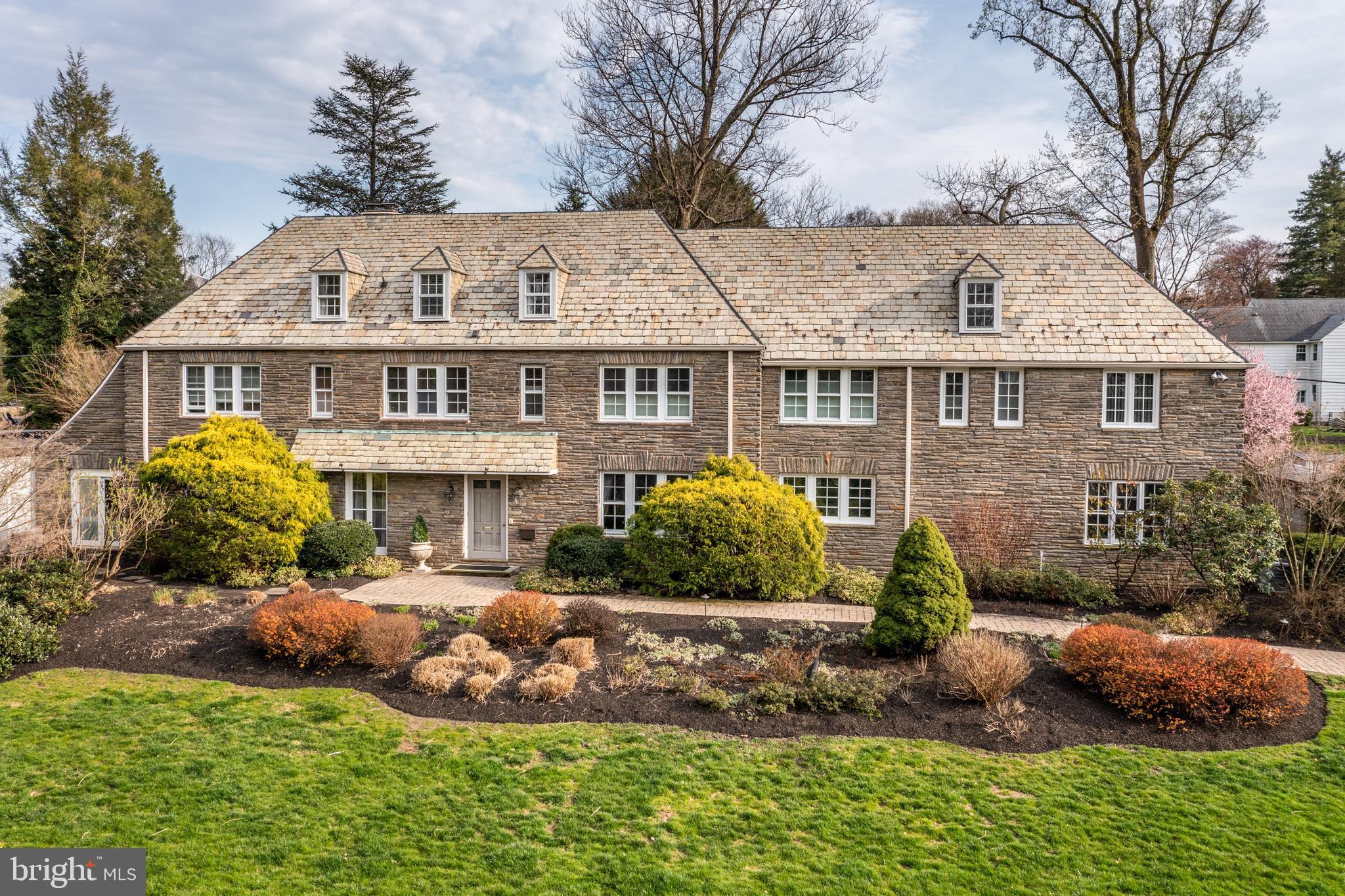 Welcome to this Updated 3 story Colonial with exquisite Pennsylvania Fieldstone exterior. It is in pristine condition and surrounded by mature plantings and custom landscaping. Luxuriously and meticulously maintained, 561 Moreno Rd is located in the highly desirable North Wynnewood neighborhood. Enter the home into a beautiful two-story Foyer which seamlessly flows into the formal Dining Room and the Living Room. The Dining room boasts French doors and gleaming limestone floors. The Living Room has new hardwood floors, large sunny windows, a gas fireplace and various technical upgrades. At the back of the house and off the large patio, there is a heated mudroom which leads to the eat-in kitchen with granite countertops, stainless steel appliances, a center island and cabinets with lots of storage. Also on the first floor is a library/den with custom millwork which connects to a spacious Sunroom with a swim spa, home gym, radiant floors and floor to ceiling California doors that fully open to the outdoor patio. There is a whole house Internet connectivity with multiple hardwired access points.New A/C and sump pump in 2022.
The 2nd floor features a Master Suite with three walk-in closets and a newly renovated bath with heated limestone floors, blue granite countertops, double sinks, a relaxing soaking tub and a tiled walk-in shower with double shower head. There are 2 additional en-suite bedrooms with built in closet organizers and an in-law suite with its own back stair to kitchen. The spacious 3rd floor has 2 additional bedrooms, full bath, closets and walk-in attic space that is perfect for your extra storage needs. The partially finished basement is ready for family fun with floating floor, powder room, laundry room and access to the outside through new Bilco Doors.
There is an active Moreno Rd neighborhood community that shares recommendations and has regular summer block parties and other activities.
This house is located in the award-winning Lower Merion School District (*Choice of Lower Merion or Harriton) within walking distance to the charming towns of Narberth and Wynnewood which include restaurants, shopping, a library, movie theater, train stations and more.
OPEN HOUSES CANCELLED