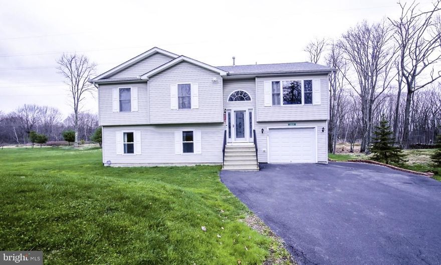 This spacious and versatile 5-bedroom, 3-bath home offers approximately 2,400 sq ft of comfortable living space and endless possibilities — perfect for a primary residence, vacation home, or potential short-term rental opportunity (buyer to verify township ordinances).

Step inside and enjoy soaring cathedral ceilings that create an open, airy feel in the main living areas and primary bedroom. The flexible layout includes a large family/recreation room, plus a bonus man-cave space that can easily serve as a 6th bedroom, office, or guest suite.

The property truly stands out with its exterior features — including extra paved driveway parking ideal for multiple vehicles or guests. You’ll also find a powered utility shed and a separate heated workshop with electricity — perfect for hobbies, storage, or projects.

Outdoor living is just as impressive with a huge rear deck for entertaining, an additional elevated deck off the dining area, and a large backyard designed for year-round enjoyment.

Conveniently located near major attractions and amenities: