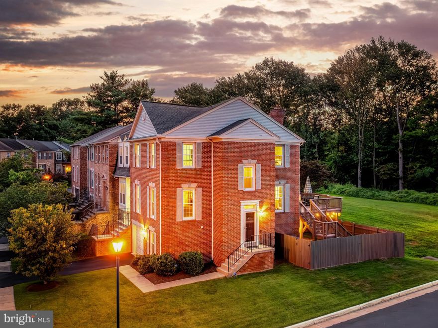 Discover refined living and commuter convenience in this luminous brick end-unit townhome offering three levels of seamless elegance and comfort. With end-unit privacy and open common ground behind, natural light pours in through plentiful windows, highlighting the rich hardwood floors on both the main and upper levels, and the warm glow of hardwood stairs with iron balusters. The oversized kitchen features abundant granite counter space, natural shaker cabinetry including dual tall pantry units, stainless steel appliances, a gas cooktop with wall oven, vent hood, and microwave, all complemented by recessed lighting. Step through sliding glass doors onto the generous deck, leading down to a fully fenced yard and lower patio, bordered by serene green space—your private outdoor retreat. Upstairs, the oversized primary suite boasts a walk-in closet and spa-quality ensuite with dual sinks, natural shaker cabinetry, a seamless glass shower enclosure, and neutral tile. A second bedroom matches the spaciousness of the master, with its own full bath. Designer paint, crown molding, custom lighting, and modern finishes flow throughout, with hardwoods upstairs and on the stairs updated just two years ago. The lower level delivers versatility with an oversized rec room anchored by a gas fireplace, direct access to the rear patio, a powder room, laundry area, and entry to the epoxy-coated one-car garage, with storage abounding throughout the home. Move-in ready with a 2024 roof and skylight replacement, and a 2014 HVAC system, this home blends aesthetics and reliability in a quiet, amenities-rich enclave. Residents of the Fair Ridge HOA enjoy an inviting outdoor swimming pool, tennis courts, and children’s play areas, all adjacent to Fair Ridge County Park with basketball courts, jogging trails, and exercise areas. A short walk brings you to Fairfax Towne Centre, featuring grocery stores, movie theaters, and restaurants, while Fair Oaks Mall, Fairfax Corner, and Fair Lakes Shopping Center offer endless retail, dining, and entertainment options. Monument Drive Commuter Parking Garage and Transit Center—just blocks away—features 820 free parking spaces, EV charging, secure bike storage, and a bus transit center with eight bays serving Fairfax Connector and Metrobus with routes running every 5–7 minutes to Vienna Metrorail, plus direct links to Tysons, Reston, George Mason University, and more, including a nonstop bus to downtown DC. With easy access to I-66 (including Express Lanes), Route 50, and I-495/95, commuting to Reston, Arlington, Washington DC, and beyond is effortless, and your access to walking/bike trails is just one block away, making 4256 Fox Lake Drive a sanctuary designed for modern living with unbeatable convenience at every turn.