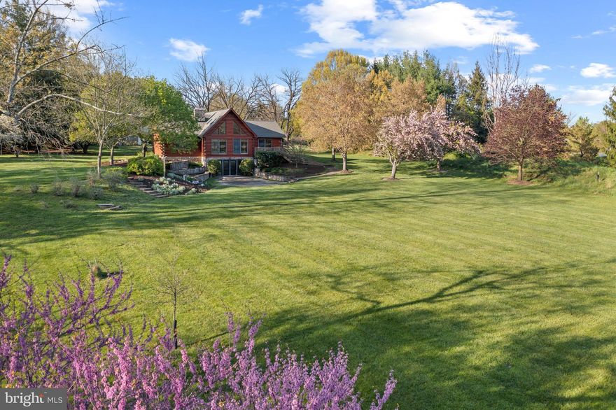 Trust your instincts. Fly fishing enthusiast, equestrian, or dreaming of creating a flower and herb farm? Discover the undeniable allure of country living on 21+ acres with a stream and shared pond only minutes from bustling Hunt Valley. Opportunity abounds as you determine how you will be inspired by the land and the structures that exist. Possibilities are endless. Bank barn with chestnut beams, farm office with full bath, 6-bay machine shed, 4-stall stable with office and half-bath, two greenhouses adjacent to growers’ farm equipment shed. The main residence is central to gathering in the handsome great room featuring  red cedar cathedral ceilings and Australian cypress flooring, a central stone wood-burning fireplace, and stunning western sunset views. The second-level office loft towers above the lower living area flanked by the main-level primary bedroom suite with a fireplace and two additional bedrooms and a bath. Eat-in country kitchen with island and gas cooking. Bright walkout basement with full bath, studio, fitness area, and second home office. Rock back on the new rear deck or expansive terrace bordered by a water garden and perennial beds to witness eagles rise from pastureland and towering native woodlands. Relish seasons exploring wildlife habitats from walking trails or find your footing through wetlands and meadows and then knee-deep into the Beaver Dam Run. Outdoor aficionados are drawn to the area known for steeplechase, riding, biking, hiking, and hunting. Convenient to great shopping and business centers, scenic by-ways, farm stands, the renowned Oregon Ridge Park and Nature Center - and minutes to the Best of Baltimore on the harbor. Please do not drive onto the property without an appointment - dog on premises.