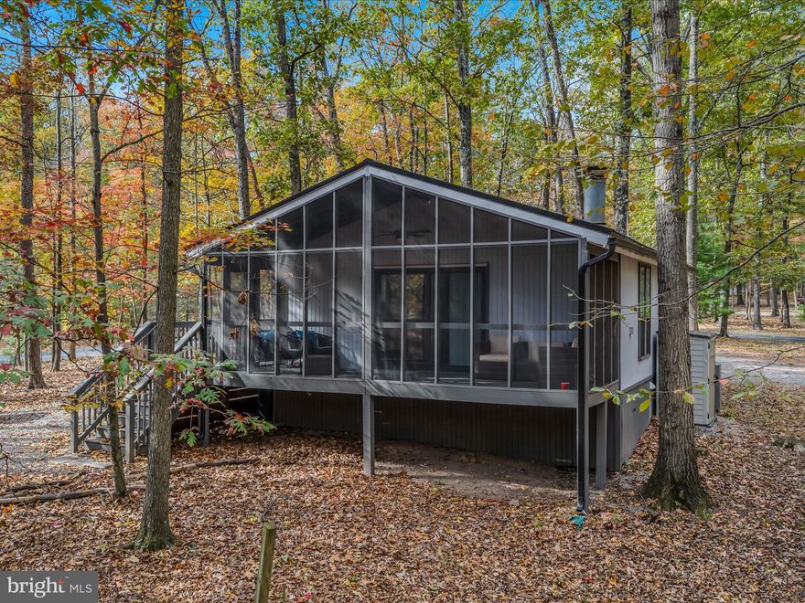 Beautifully renovated cabin-style home that is sure to impress. This cozy retreat features a screened porch, perfect for enjoying your morning coffee, and an outdoor firepit area or indoor wood burning fireplace for evening relaxation—don’t forget the marshmallows for roasting! The home offers 2 bedrooms and 1 bathroom with a tiled shower and tub area, as well as a stackable washer and dryer closet. Guests will love the convenient coffee bar area. The seller currently holds a Class B Membership to amenities, which you can choose to join. The kitchen boasts stainless steel appliances, a tiled backsplash, and granite countertops. This property has over 250 5 star reviews on AirBNB and VRBO and consistently generates good short term rental revenue. Currently under professional management, the new owner can choose to continue with the current listings and see immediate benefit. With a successful short-term rental history, this gem won’t be on the market for long!