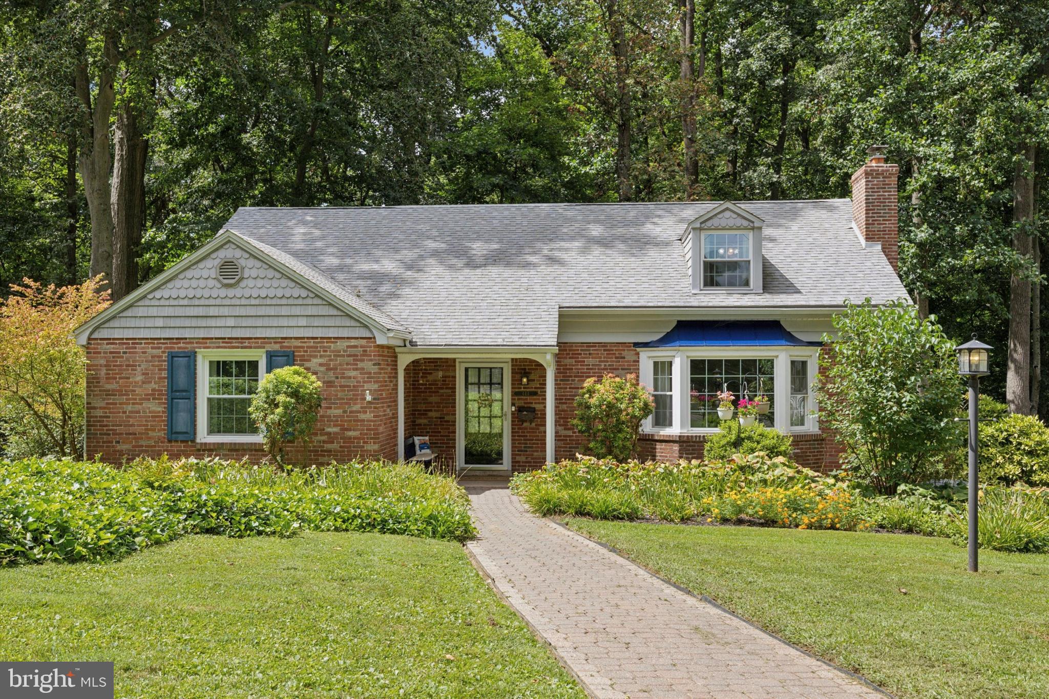 Welcome to 444 Kerr Lane! This charming brick Cape Cod offers character and modern updates, featuring 4 spacious bedrooms, 2 full bathrooms, and a relaxing three-seasons room with views of Kerr Park. From the inviting paver walkway to the covered front porch, this home greets you with warmth. Step inside to a foyer with a large coat closet and continue into the bright living room, complete with a picture-perfect bay window and a cozy fireplace framed by custom built-ins. The adjoining dining room is filled with natural light and additional built-in shelving for display or storage. The kitchen is boasting oak cabinetry, granite countertops, stainless steel appliances, a coffee bar, and island seating for three. A convenient laundry closet blends right in. Just off the kitchen, enjoy the three-seasons room overlooking a wooded view, with access to the low-maintenance TimberTech deck (15 x14) with steps to the driveway, perfect for entertaining or relaxing. The main level offers a spacious primary bedroom and an additional bedroom, both with large closets. A full hall bath features a tub, stall shower, and updated vanity. Upstairs, you’ll find two generously sized bedrooms, a second full bath with new vanity, and a walk-in cedar closet. The basement expands your living space with a versatile rec room, ideal as a family room, play area, or gym. Plus a utility/workshop area and access to the oversized 25x14 one-car garage. IDEAL LOCATION. Award-winning Springfield School District. Easy access to Rt 1, 476, and SEPTA Regional Rail (Media/Elwyn Line). Close to shops, restaurants, Springfield Mall & Springfield Country Club. Don’t miss your chance to make this beautiful home yours. Schedule your private showing today, because home is where your story begins!
