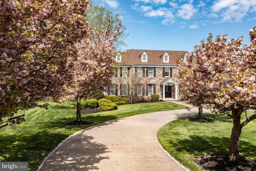 Situated on a prime 2.88+ acre site in the community of Meadowood, this expansive custom-built 
stone fronted home features three levels of living space, five en-suite bedrooms, a full finished 
daylight walk-out lower level, and an array of outdoor amenities including a  heated salt 
water pool with diving area and waterfall, basketball court, sprawling wrap-around deck, and paver  
terraces for entertaining. A circular driveway to the double front door leads to a center foyer, flanked by 
formal living room and dining rooms, the dining room with Butler area with built-ins and granite 
counters.  A conservatory with tile floor and window surround is a great respite for watching TV, 
reading, or enjoying guests. A spacious step-down great room is enhanced by a stone gas fireplace 
and custom floor-to-ceiling built-in bookcases and shelving. Nearby is a large, sunny
kitchen/breakfast room, with a Viking gas range, center island with granite counters, and room for a 
dining table for everyday enjoyment.  A solarium just off the kitchen allows access to a two-level 
composite deck, overlooking the private rear yard and pool area below. The first floor also offers 
two powder rooms, a laundry with built-ins, and access to the oversized 3-car side entry garage. 
Upstairs, the gracious main bedroom suite includes a his/hers bath, joined by a shower for 
two, and a jetted tub, and large walk-in closets. In addition, four en-suite bedrooms have been 
enhanced with newer laminate “wood” flooring, each with a tile bath with tub and shower head.  
The lower level, a full walk-out with double hung windows, has ample entertainment space with a 
gathering room, game room, media room with projector and screen, gym with mirrored wall and 
specialty flooring, kitchenette, and flex room and full bath, great for in-law quarters or extra company. There is also a workbench/utility room with double door access to the outdoors- handy for lawn, garden and patio furniture storage. The rear yard backs to woods, and is extremely private, beautifully manicured, and its own mecca for enjoyment.  In addition to the oversized pool with diving area, a basketball/sports court could also be converted to a pickle ball court, or riding bikes or roller skating. There is also a storage she, and a nearby garden with a water source available.  With meticulous landscaping and flowering 
trees and shrubbery,  garden irrigation, a back-up generator, newer roof, zoned HVAC, central music 
and central security, this private oasis on almost 3 acres epitomizes a wonderful lifestyle amidst natural 
beauty, with room for everyone, in a highly convenient location in Upper Makefield.
