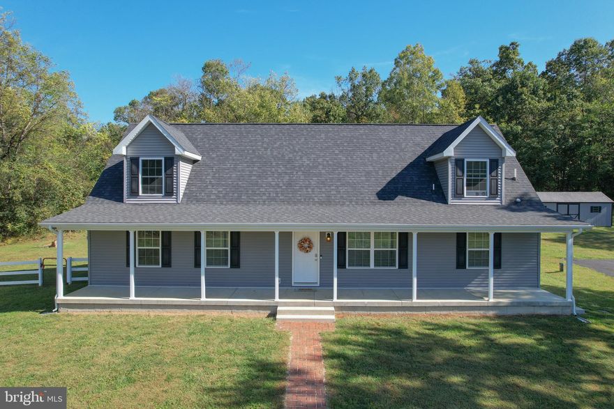 A Secluded Retreat with Room to Grow—No HOA, Unlimited Potential

Escape to your own private retreat on five unrestricted acres with no HOA. Surrounded by trees and tucked away from the road, this Cape Cod combines modern comfort with the peace and privacy of country living. Inside, the 1,882-square-foot layout features three bedrooms, two full bathrooms, and a spacious bonus room upstairs that can be used as a fourth bedroom, home office, or cozy lounge. An additional unfinished space is already framed and ready to finish, offering endless potential to grow and customize.

Freshly painted interiors make this home move-in ready, while central air and a heat pump keep you comfortable in every season. The large front porch and brick walkway create a welcoming entrance and the perfect place to enjoy your morning coffee or evening sunsets. Outdoors, you’ll find two detached outbuildings with garage doors, ideal for storage, a workshop, or hobbies, along with a paved driveway offering parking for up to five cars.

This property combines the freedom of no restrictions with modern convenience. Public sewer and a private well are in place, and both Comcast and Frontier fiber internet are available for fast, reliable connection. Just minutes from Martinsburg and commuter routes, this home offers the best of both worlds—peaceful country living with quick access to town.