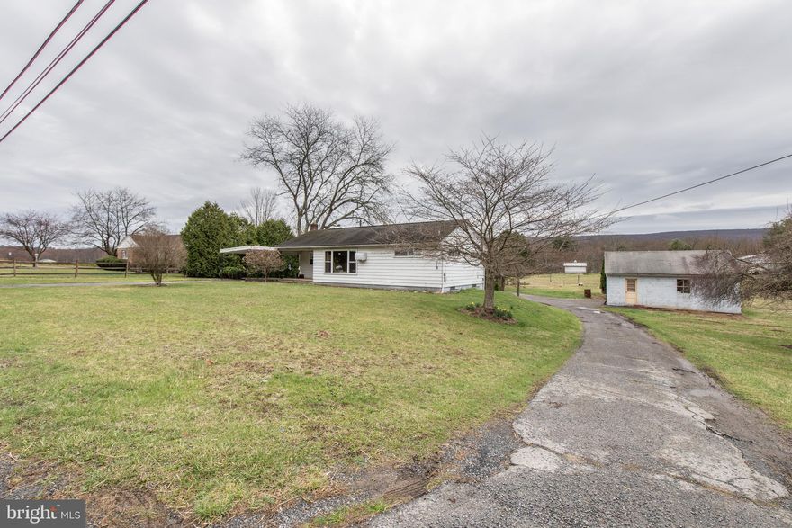 Enjoy single story living on a level 1.5 acre lot with views of the Blue Mountain.  Located between routes 309 and 61 this three bedroom ranch home is ready for a new owner! The interior has a large eat-in kitchen with plenty of counterspace.  The living room and the bedrooms have hardwood floors throughout.  The home has updated mechanicals.  A new 200 amp electric panel, new electric hot water heater, water treatment system, and a newer oil burner.  The exterior of the home has a covered carport that leads into the kithcen.  The basement has a one car garage entrance and over a 1,000 square feet of open space.  Detached from the home is a two car garage with an attic space for storage or a workshop.  Do not miss the opportunity to own the rancher everyone asks about!!