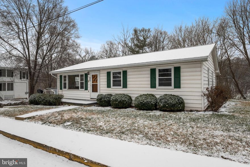 Charming Home with Endless Potential & Serene Creekside Setting

Looking for a home that offers both convenience and a peaceful natural setting? This 3-bedroom, 1.5-bath charmer provides over 1,200 square feet of main-level living space and is just waiting for your personal touch!

Nestled in a prime central location, this home is within walking distance to town—perfect for catching parades, enjoying local shops, or grabbing a bite to eat. Love the outdoors? Step out your back door and head down to Stoney Creek, where you can fish, wade in the water, or simply relax to the soothing sounds of the stream.

Inside, the welcoming front porch leads you into a living room that flows seamlessly into a large eat-in kitchen and then onto an enclosed sunroom—ideal for entertaining. Down the hall, you’ll find three comfortable bedrooms and a full bath. The cozy sunroom just off the kitchen opens to a covered back porch, where you can sip your morning coffee while taking in the peaceful creekside setting.

The lower level, offering approximately 1,060 sqft, expands the home’s potential with a laundry area, half-bath setup, and a one-car garage. There’s also ample unfinished space—perfect for a workshop, game room, storage, or even additional living space.

With its solid structure, traditional layout, and unbeatable location, this home is a rare opportunity to enjoy the best of both worlds—small-town charm and nature’s beauty just steps from your backyard. Come see the possibilities for yourself!

*See documents section for information relating to removal of house from flood plain*