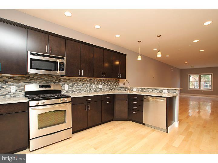 A gorgeous new construction Pennsport home with 1 car parking that is simply irresistible! One in a six home community scheduled for completion in June, enter and find all the details you'll adore, from the natural oak hardwood floors which are finished on-site, to the recessed lighting and large windows throughout the home. Enter to find the open living and dining room floor plan, perfect for entertaining friends and family. The open space also showcases the modern kitchen with sleek stainless steel appliances - act now and add your own personal style, with a wide variety of choices in granite or quartz countertops and a varied selection of cabinetry. The second floor reveals a conveniently located laundry room, two spacious bedroom with tons of natural light and closet space, and their own ensuite bathrooms, complete with tile flooring and lovely vanities. Discover the impressive master suite, with its vaulted ceilings, large walk in closet and full bathroom complete with an immense double vanity with a granite or quartz counter of your choice, and a fantastic full shower with a frameless glass enclosure. The wet bar with sink and fridge is just the spot to store your beverage of choice, so you can grab a cold one before relaxing in the sitting area, or before heading up to the roofdeck to take in the gorgeous view of the city. For those who need an extra rec room or home theater, check out the finished basement, complete with plush wall to wall carpeting and a full bath with tile flooring and walk in shower. All of this, along with an approved tax abatement? What are you waiting for?! See it today! Photos are of a similar property.