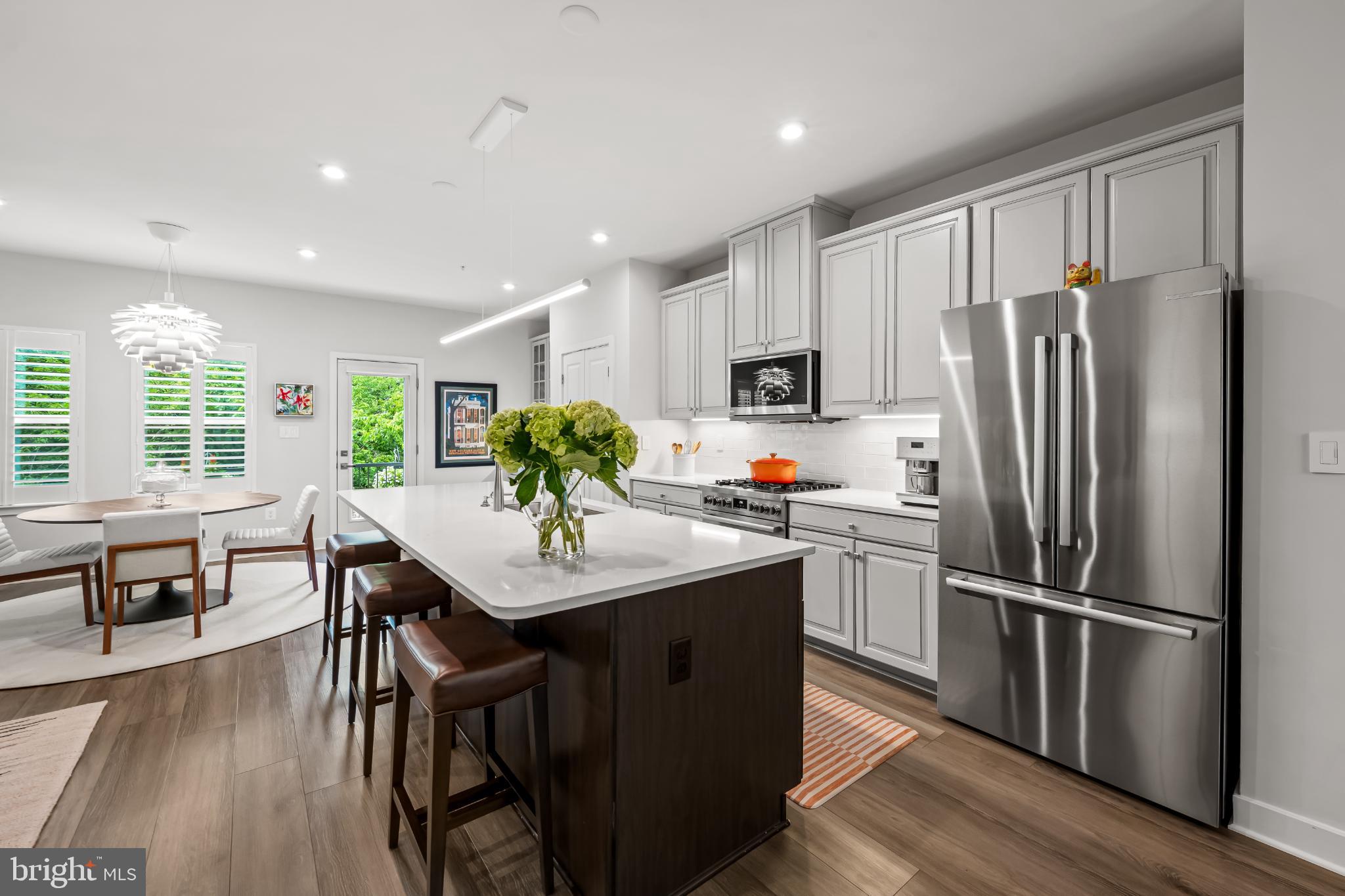 Welcome to Banner Row, Locust Point’s premier new construction townhome community. If you've been looking for space to spread out and easy parking all while being in the heart of Locust Point, this is the perfect home for you.
Pull into your two car garage that provides entry right into your first floor. Also on the first floor is a bedroom and private bath plus extra storage. This makes a great guest room or office/den space.
The main level features an open-concept floor plan with an oversized kitchen and island that flows into a bright living room, ideal for entertaining. The main floor also has a sitting area and separate dining space with abundant natural light and access to a private balcony. The kitchen has wonderful upgrades like Bosch appliances, island pendant, and custom coffee bar. Because this home is an end-unit you have extra windows on each floors providing beautiful natural light throughout the day.
Upstairs, the primary suite includes a large walk-in closet, and spa-like bath with soaking tub, separate shower and dual vanities. Two additional bedrooms, a full bath, and second-floor laundry (with upgraded washer and dryer) complete the third level.
The fourth level loft offers additional living space with a full bath, perfect for a home office, guest suite, or recreation room. The owners also thought ahead and already had the rough-ins (water access/drainage) installed for your future wet bar. Best of all, it opens up to a rooftop terrace- perfect for summer nights.
Additional upgrades include custom closet systems in every closet, Lutron lights, home automation and integrated WiFi access points throughout the home, and custom shutters and window treatments. Not just a "plain new build box", but a thoughtfully designed and upgraded home, ready for its next owner.
Enjoy a walkable location near McHenry Row with groceries, salons, gyms, and restaurants all nearby. Conveniently located to Federal Hill and the Baltimore Peninsula. Recreation, cultural attractions, and sports venues—including Fort McHenry, the National Aquarium, Camden Yards, and M&T Bank Stadium—are all within easy reach.
This home combines modern design, functional space, and unbeatable location—perfect for enjoying the very best of city living.
