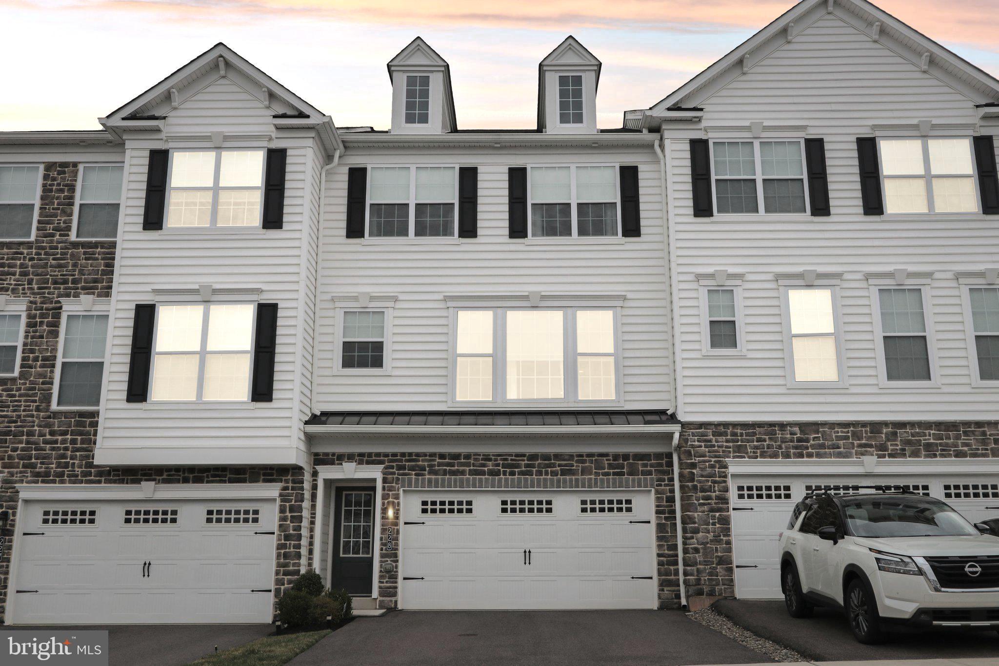 Welcome home to 228 Cadence Court—a stunning 3-bedroom, 2.5-bath luxury townhome in the highly sought-after Courts at Brynwood community in Collegeville. Nestled on a picturesque street overlooking the charming gazebo and play area, this meticulously maintained home offers elegance, comfort, and modern convenience. Not even five years old, this exquisite residence showcases thoughtful design and premium finishes that are sure to impress. The lower level features a beautifully finished living space with a walkout paver patio, providing exceptional versatility for today’s dynamic lifestyle. Whether you envision a cozy playroom, a stylish lounge, or a productive home office, this bright and inviting area adapts effortlessly to your needs. The main floor boasts an open-concept design, seamlessly blending style and functionality. Gorgeous luxury plank flooring flows throughout, complementing the upgraded cabinetry and pristine neutral quartz countertops. A spacious, 8-feet long island serves as the heart of the kitchen—perfect for entertaining and meal prepping. High-end, upgraded stainless steel appliances compliment the space, including a sleek refrigerator with dual drawers and a powerful fast-boil burner on the premium electric cooktop (a gas line is already in place for added flexibility!). As warmer days approach, step outside to enjoy your morning coffee or unwind with an evening drink on your deck located right outside the dining room, a cozy space with an unobstructed view of the beautiful green landscape.The upper level is home to the primary suite, featuring a spacious walk-in closet and an upgraded en-suite bath featuring a dual vanity with lots of counter space and a glass-enclosed stall shower with a built-in bench. Two additional, bright and spacious bedrooms feature beautiful views of the central park area comprised of a community gazebo, fenced in tot-lot, and open green space. A stylish full bath and a conveniently located laundry room complete this upper level. The spacious two-car garage includes an universal electric car charger, two steel overhead shelves, a tools organizer and a spacious storage area, maximizing prime organization and functionality. Guests will love the easy access to guest parking across the street. Located within the highly rated Methacton School District, this home offers unparalleled convenience, just moments away from premium grocery stores, Providence Town Center, shopping, restaurants and more. The area also boasts several parks and the multi-use Perkiomen Trail and Evansburg State Park, perfect for nature lovers. Other nearby travel destinations include the King of Prussia Mall, Philadelphia Premium Outlets, Peddler’s Village, Peace Valley Park and Tyler State Park. Easy access to travel routes Rt. 422, Rt. 202, the PA Turnpike, and Norristown High Speed Line ensure you can get where you want to go quickly and conveniently. Come see this wonderful property and imagine making it your own! Contact us today to learn more and schedule a tour of this wonderful home!