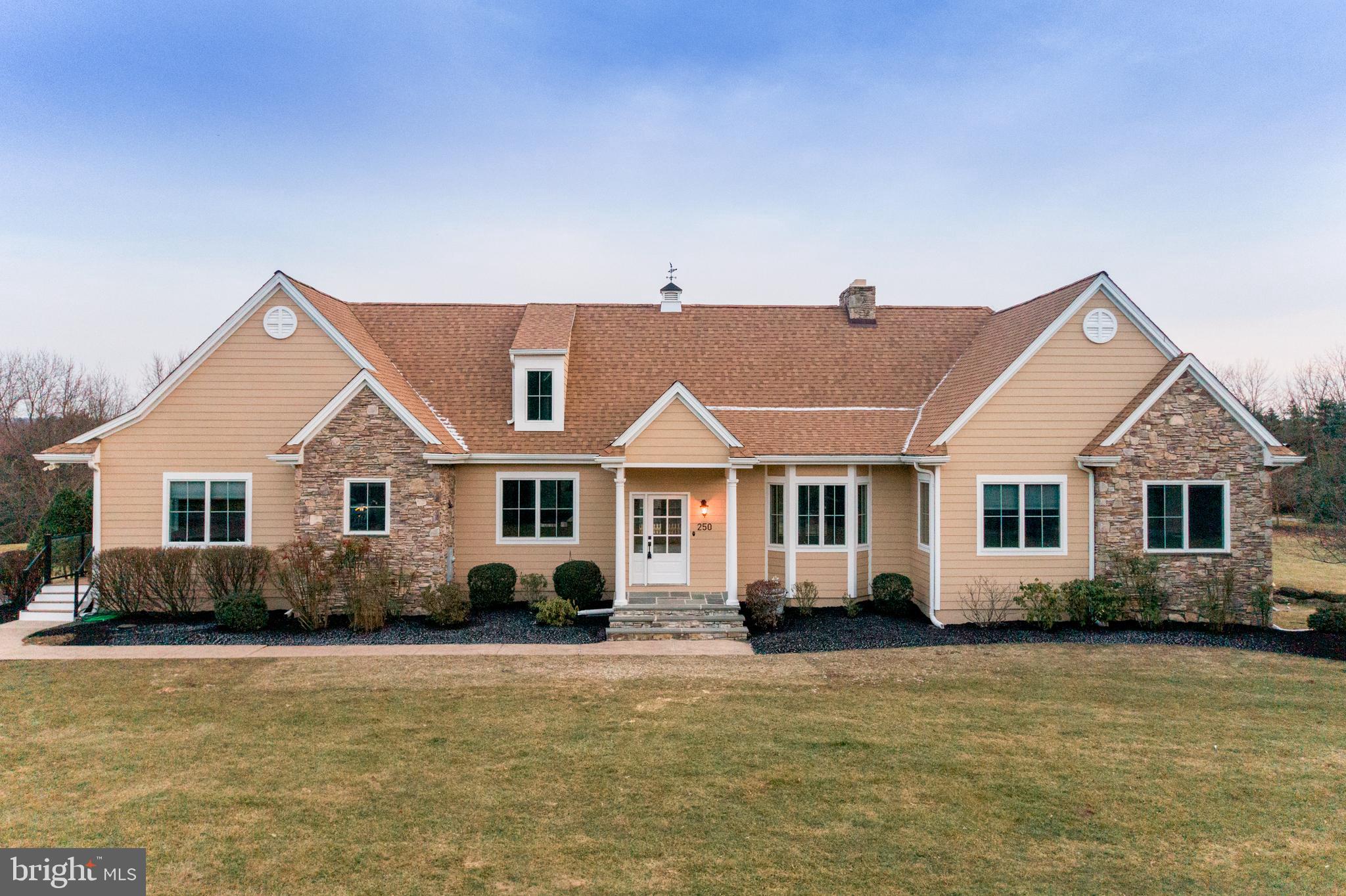 Introducing this absolute stunning, one of a kind, French country manor home sitting on 3.5 acres in the heart of Bucks County! This custom designed home offers one floor living space at it's finest with new hardwood flooring throughout. Sun-drenched and spacious best describes this open and flexible floor plan. A gourmet designed kitchen w/ breakfast area opens to the great room with cathedral ceilings and a statement stone hearth fireplace. The kitchen boasts large island with seating, wood cabinetry and stainless steel appliances, new countertops and backsplash that's perfect for entertaining. From the living space access the new Timberteck deck. The bedroom wing features a primary suite with large walk-in closet with private full bathroom boasting stall tile shower, Jacuzzi tub, high ceilings and double vanity sink. There are also 3 generous size bedrooms and 1 hall bathroom with tub shower. Additionally, there is a separate living quarters that can be used as an in-law suite/guest suite flanking the kitchen with vaulted living room space and has stairs leading to two additional bedrooms. Room to grow with an unbelievable 4000 sq ft unfinished walkout basement featuring stone double sided fireplace. The lovely deck overlooks the salt water in-ground swimming pool with new fence and green surroundings. Stroll over to the 2 bedroom guest cottage complete w/ full kitchen with new vinyl flooring, great room and charming deck. This secluded space is perfect for guests or Airbnb rental or use as a home based business! If you're looking for something special and want to enjoy the spectacular views, this home truly has it all! Also worth mentioning- there are 2 Generac backup generators so you never have to worry about power outages, new well line, new lifetime roof, new heating and air, entire interior and exterior of this home has been repainted. This home is located in the award winning Council Rock School district.