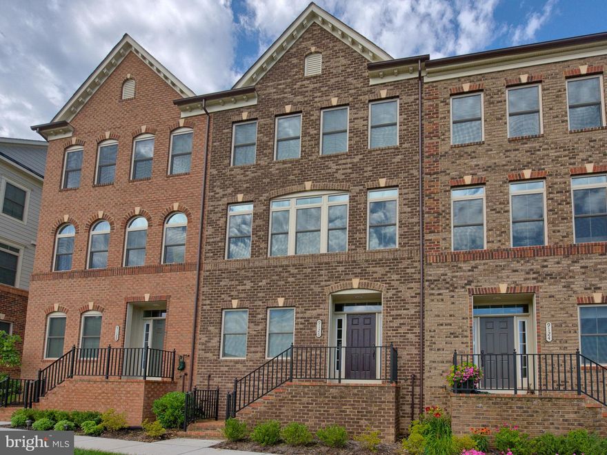 This spectacular brick-front Villages of Urbana home shows like a magazine feature! It looks brand new! With four fantastic levels, an attached two-car garage, serene pond view, and upgrades throughout, including hand-scraped hardwood floors and a 4-level bump out. On the lower level, enjoy the second family room and storage area--perfect for a home office or virtual learning area. The open concept main level features a living area, fantastic chef's kitchen and eating area! You'll love cooking and entertaining in the gourmet kitchen with the expansive granite island, breakfast bar, upgraded granite counters, upgraded cabinets and stainless steel appliances! The expansive Owner's Suite features a beautiful spa-like bathroom with a huge custom-tiled shower. Enjoy the convenience of two walk-in closets and the upper level laundry. All this, plus two more large bedrooms and an additional hall bathroom. The fourth level features an additional bedroom, huge walk-in closet, full bathroom, and rooftop terrace. Within a 5 minute walk from this home you can reach all the amenities that Urbana has to offer--Blue Ribbon schools, the grocery store, restaurants, Starbucks, the library and all the Urbana town center businesses. Cool off at one of the two Villages of Urbana pools, including the new resort-style pool with a lazy river and clubhouse with a work-out room. This home offers the utmost in luxury and convenience. It won't last long!