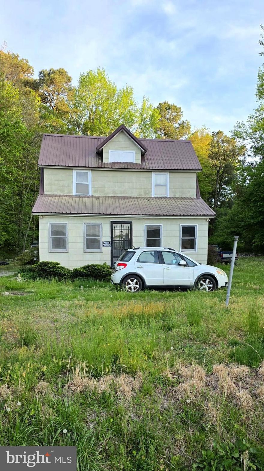 Escape to country living with this charming 1.5 story home. A sturdy metal roof promises decades of durability, and a wood-burning stove anchors the living space, creating an inviting atmosphere full of warmth. on those cooler evenings.  Floor joists were replaced about 20 years ago. The front of the house foundation is pillars while the back of the house foundation is concrete block.  This cozy home is a prime fixer upper opportunity for a savvy buyer looking to add value, with 936 sq ft featuring 3 bedrooms and 1.5 baths.
Step outside to a sprawling one-acre lot setting, and you'll immediately appreciate the privacy and country atmosphere. Mature trees add shade and natural beauty throughout the seasons. With neighbors at a comfortable distance, enjoy the starlit skies, fresh air and the peaceful solitude that only country living can bring.

The sizes and/or square footage of the property is not guaranteed. Buyer should do their own due diligence and measure the property and confirm all information is to their satisfaction including tax information and schools. Escrow Deposit Checks are to be made payable to either your broker or the title company but not to Coldwell Banker. This property is being sold as-is. Seller will not make any repairs.