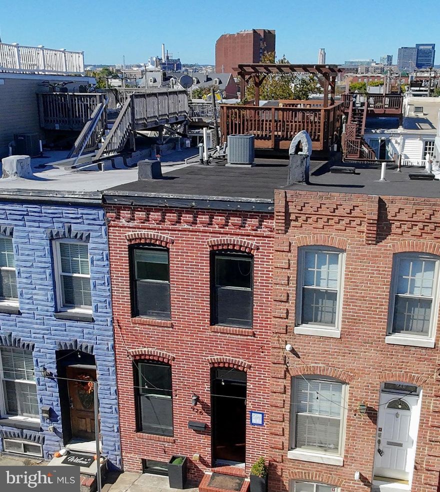 Welcome to this beautifully maintained and freshly painted three-bedroom, three-bath home located in one of Baltimore’s most sought-after neighborhoods. The main level features a bright, open layout with a modern kitchen equipped with everything you need for cooking and entertaining. From the kitchen, step directly outside to your private parking pad for added convenience.

Upstairs, you’ll find two generous bedrooms and two full baths, including a primary suite with an attached bathroom. The second bedroom features a walkout balcony that leads up to your private rooftop deck, ideal for relaxing or entertaining while enjoying sweeping city views.

The fully finished lower level offers a spacious bedroom with a full stand-up shower and additional storage space—perfect for guests or a home office.
Don’t miss the opportunity to call this move-in-ready Canton gem your new home!