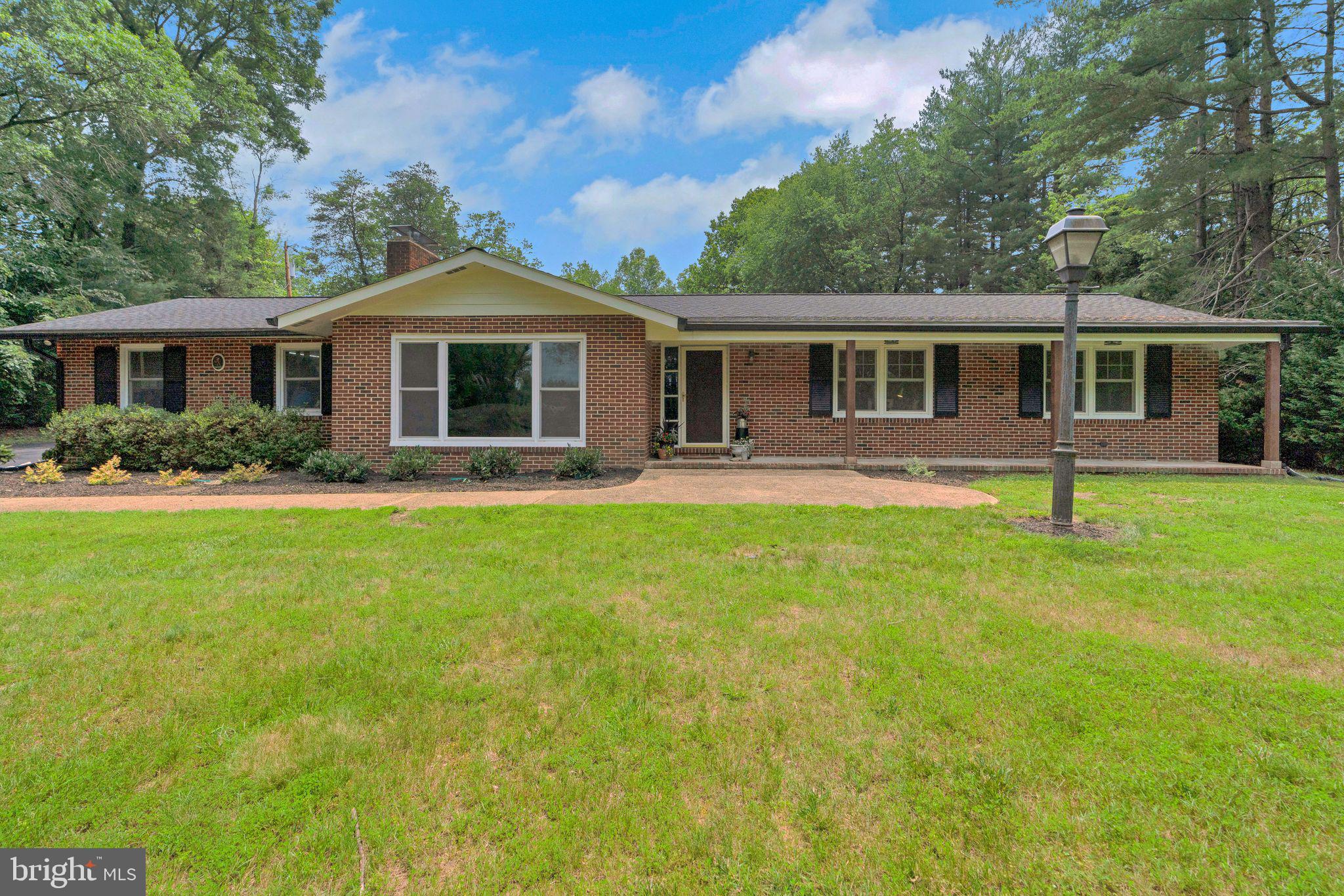 SWEET SERENITY: ONE-LEVEL LIVING IN DAVIDSONVILLE. Nestled on nearly 2 acres of park-like grounds, this beautifully updated ranch home offers the perfect blend of peaceful seclusion and modern convenience. Located just minutes from major highways, shopping, dining, and entertainment, you’ll enjoy the serenity of country living while still being close to all the amenities you need. Upon arrival, the expansive parking area provides ample space for both residents and guests. The newly reconfigured and remodeled kitchen is a chef’s dream, featuring sleek quartz countertops, a custom tiled backsplash, a large center island, a 5-burner propane cooktop, and an added walk-in pantry. Perfectly situated at the rear of the home, the kitchen offers easy access to outdoor living spaces, making it ideal for entertaining or relaxing outdoors. The inviting great room boasts a cozy gas fireplace and a large front window that frames serene views of the lush front lawn, creating a tranquil and scenic atmosphere. The primary bedroom suite offers a spacious walk-in closet and a fully renovated ensuite bathroom with a walk-in shower, elegant tiled floors, and a double vanity. Two additional generously sized bedrooms share a beautifully updated hall bathroom, also featuring modern finishes. Step outside and discover a large, flat, private lot, perfect for enjoying the outdoors in peace. A 16’x20’ pole barn with a lean-to and an additional shed provides ample storage options, while a charming fire pit offers the perfect setting for cozy evenings under the stars. Additional upgrades to the home include new windows, a 5-year-old roof, a newer well, and NO HOA—allowing you the freedom to truly make this home your own. This move-in-ready gem offers the ideal balance of convenience, comfort, and privacy. Don’t miss the opportunity to make this serene retreat your own!