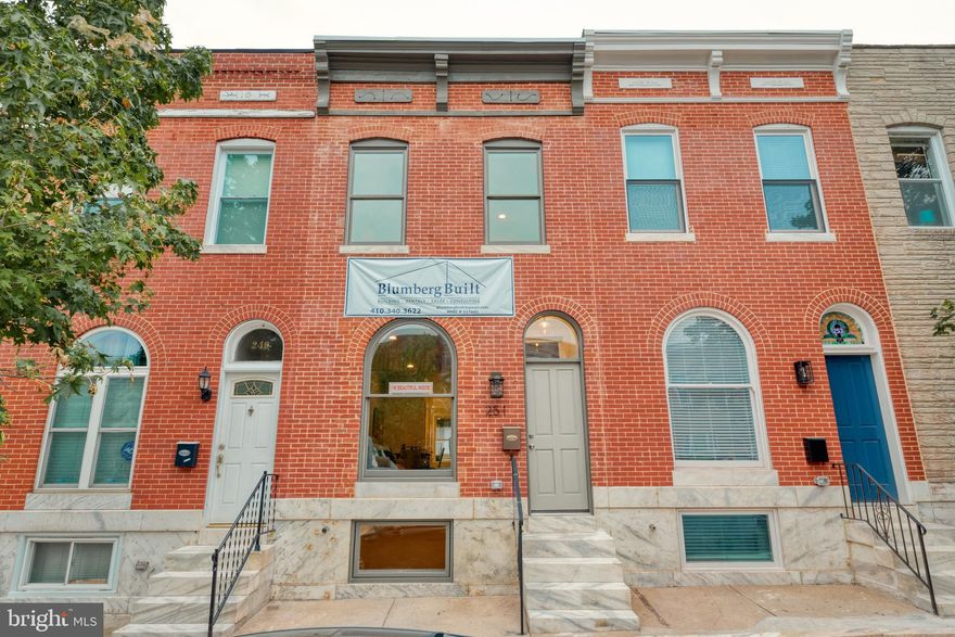 JUST REDUCED to under $350k!!! Incredible FULL RENOVATION including LARGE PARKING PAD, ROOFDECK, and CHAP tax credit (pending final). This Blumberg Built 4BR/3.5BA is loaded with upgrades. Enter beneath the historic arched doorway and transom to find a spacious, 13-ft wide interior. Exterior light shines in abundance from the oversized front window, transom, and skylights at the second floor. The first 2 levels are finished with gorgeous hardwood flooring which contrasts wonderfully with the exposed brick leading up the entire stairway wall. In the main level you'll find a half bath,  a 3x3 pantry, and a brand new gourmet kitchen with oversized island incl quartz tops. The kitchen contains whirlpool SS appliances including vented mircohood. Venture to the second floor to discover the master suite. Master bathroom features custom tilework, custom glass surround, and rainfall showerhead. Included with sale is a  state of the art LG washer/dryer on 2nd level. 2nd lvl hall BA offerss tub/shower combo, custom tile, and skylight. The large rear BR provides access to the back 10x13 deck and the giant 12x19 rooftop deck (complete with spigot and electric). Basement is the cherry on top with a LEGAL 3rd BR for roommates, addt'l family room, and 3rd full bath. Basement newly waterproofed, all mechanicals are new. New water service to street and brand new roof. Basement currently setup with BR and Den but builder willing to add wall for 4th true BR if Buyer desires! 1 YR builder warranty provided with sale - don't miss it!