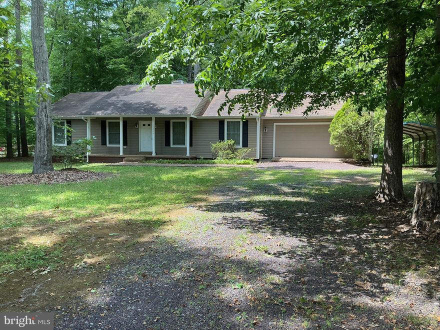 Great lake home or starter home for 1st time home buyers with 3 bedrooms, 2 bathrooms, a gas fireplace in the dining room, and approximately 1400 sq. ft., finished with an oversized garage and carport. The house has a newly installed conditioned crawlspace. In addition to the amenities, a boat slip in the Common Area conveys.  The home has been well-maintained and has significant potential to increase in value.  It is in a wonderful community with a common area, a large picnic area, boat docks, and a boat ramp.