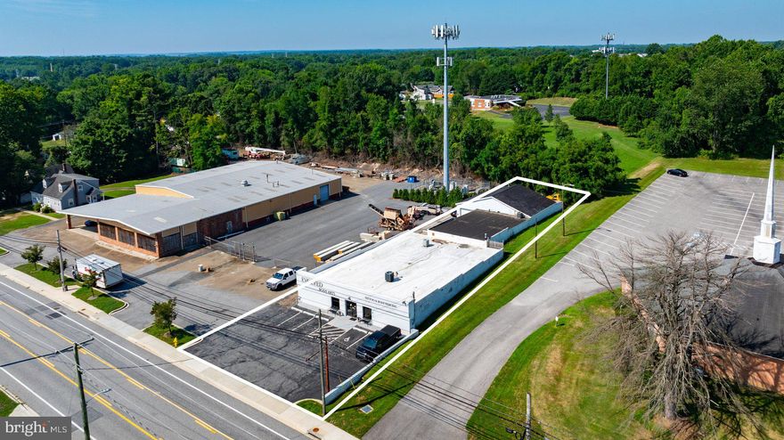 Great opportunity to own an income producing property or for someone to owner occupy while receiving rents from the other rentals within the building paying for your mortgage.  This block building has been well maintained with a 7 year young roof.  The building has the potential for 5 rental spaces with currently 2 tenants in place (salon w/separate entrance & a large shop at back of building with 2 garage doors/office/bath).    The third space is owner occupied whereas the  owner can stay on as tenant or move out depending on buyer needs.  The last space is a shop/storage room with a garage door & office space/2 baths, the space has 2 separate entrances and can be rented out as 1 unit or split up into 2 additional rental units.  Lots and lots of potential with many possible uses.